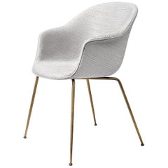 Chaise de salle à manger Bat, entièrement tapissée, base conique, laiton semi-mat