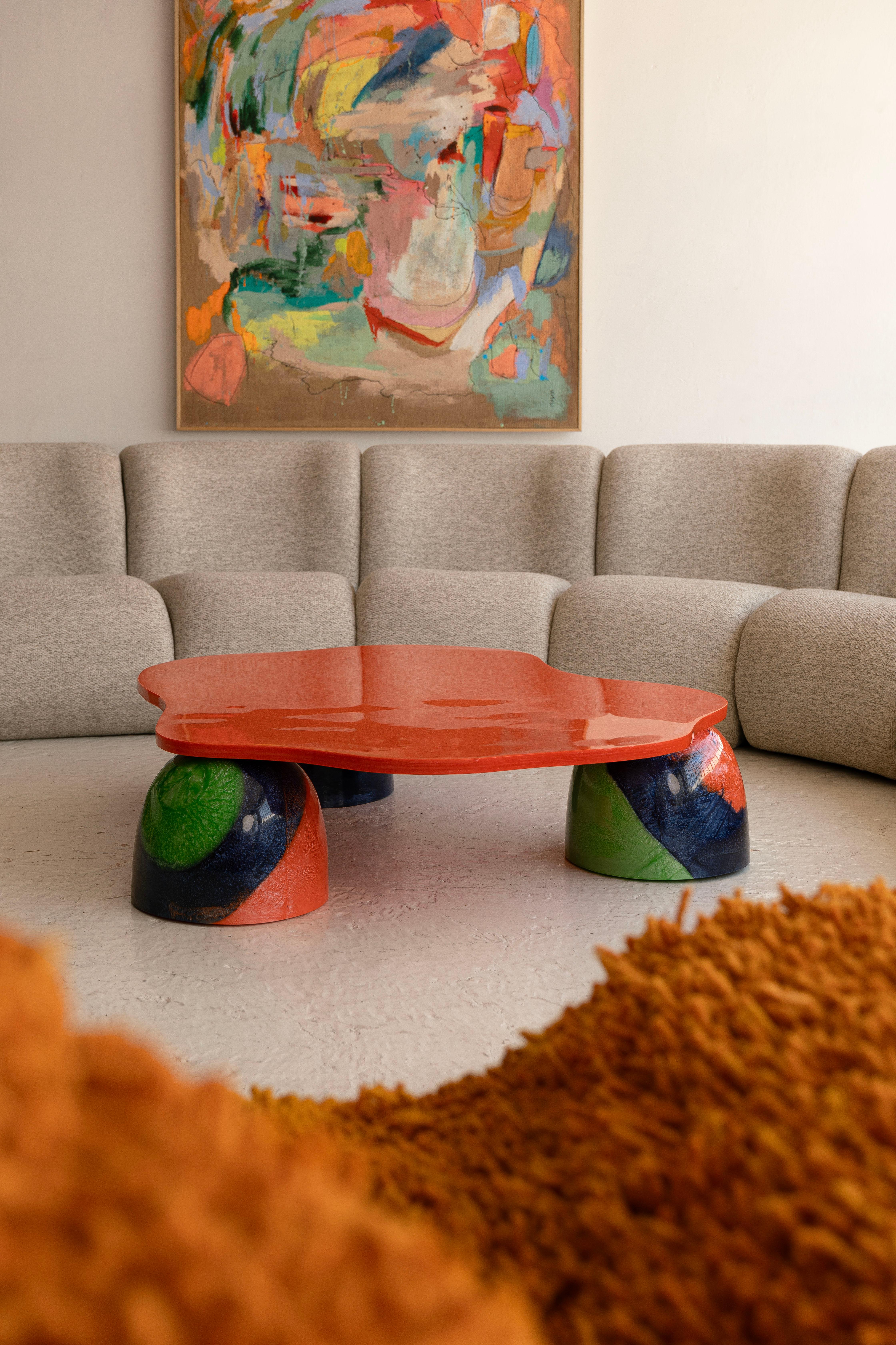 Our Batarà coffee table is inspired by the colorful birds of the Amazonia, a reminiscent of the fallen feathers of the yellow and blue macaws, this piece made in metallic colorful resin brings a tropical air to every space.