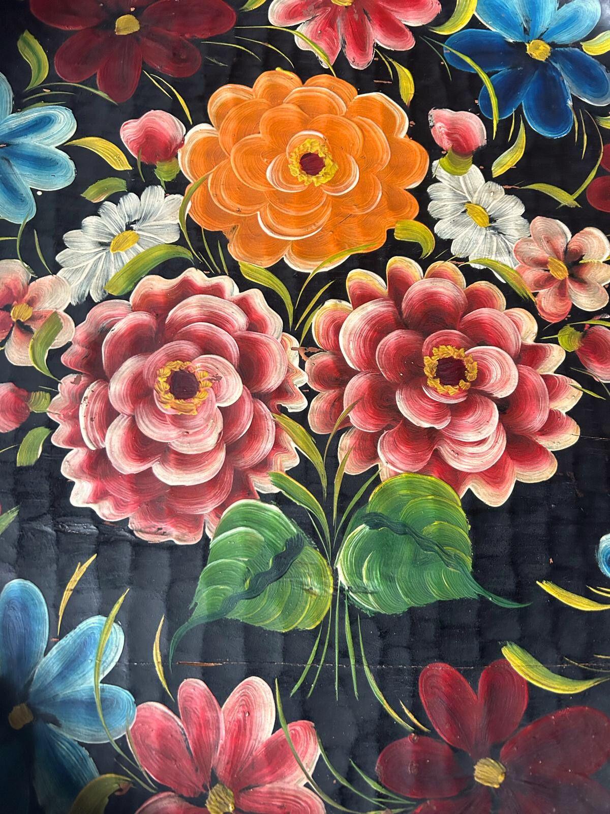 Esta exquisita batea michoacana es una pieza única de arte popular mexicano, hecha a mano por artesanos del estado de Michoacán. Tallada en una sola pieza de madera, su superficie cóncava ha sido meticulosamente decorada con motivos florales