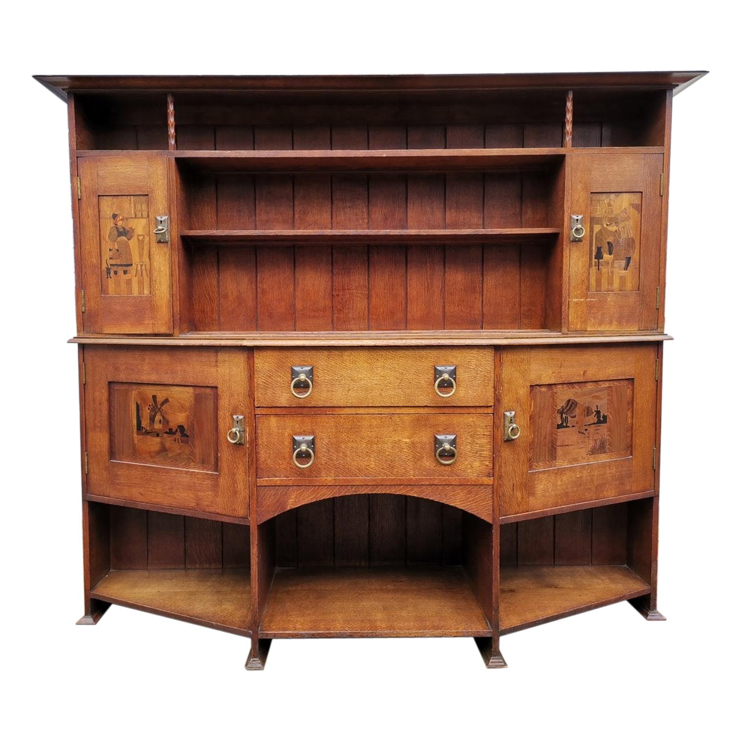 Bath Cabinet Makers, an Arts & Crafts Oak Sideboard with Dutch Inlaid Scenes