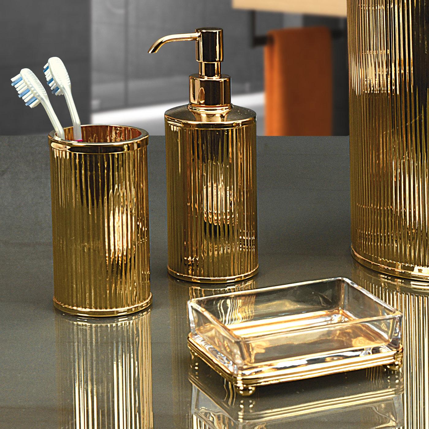 An elegant way of accessorizing a traditional- or modern-style bathroom, this set of toothbrush holder, soap dispenser, and soap holder exudes an utterly lavish and sophisticated character. Handcrafted of brass and glass finished with galvanized
