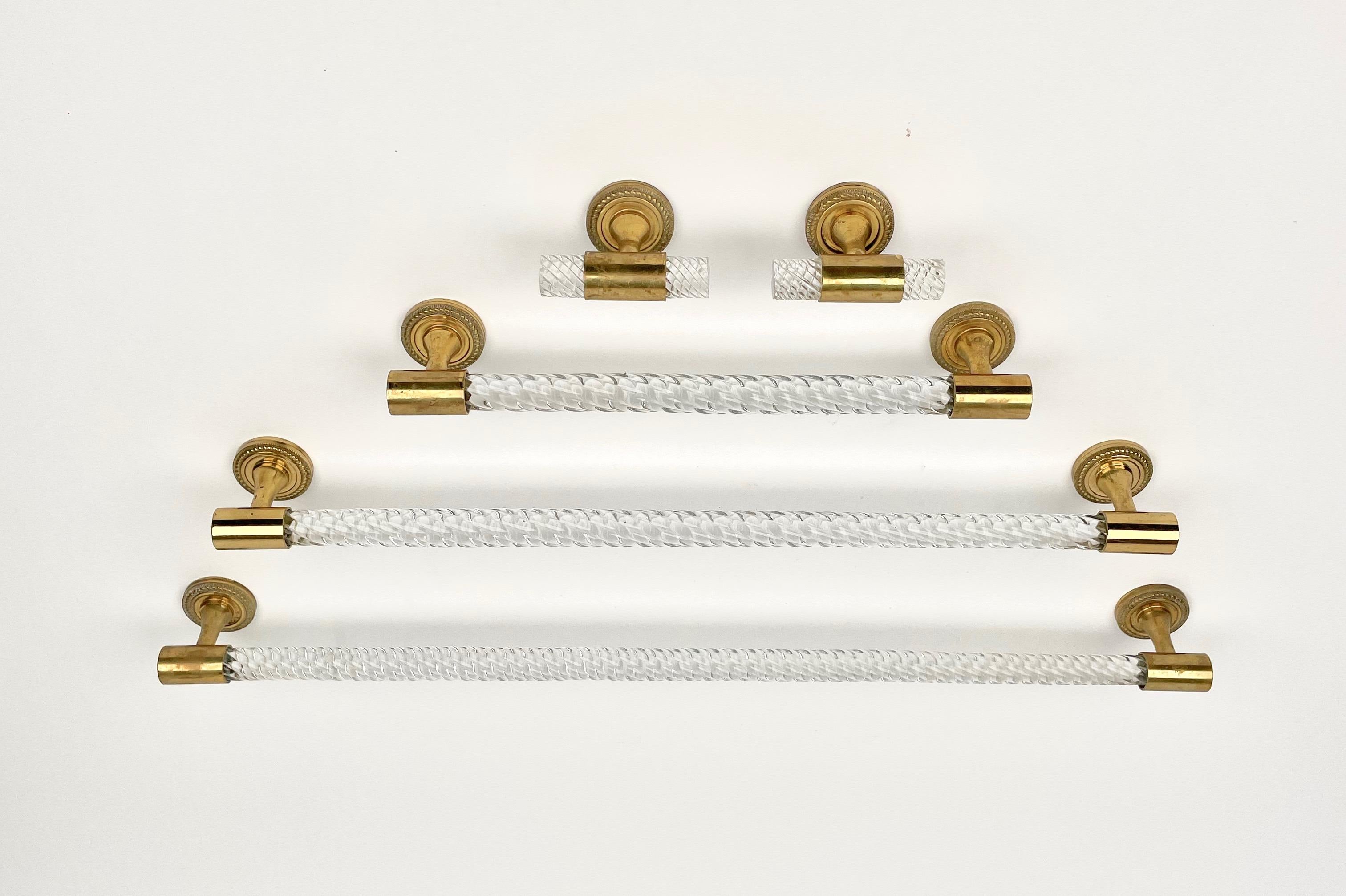 Bathroom set of towel holders in transparent Murano glass and brass details made in Italy in the 1950s.

Dimensions: l
Width 62, Height 2.5, Depth 6.5 cm.
Width 54, Height 2.5, Depth 6.5 cm.
Width 32, Height 2.5, Depth 6.5 cm.
Width 8, Height