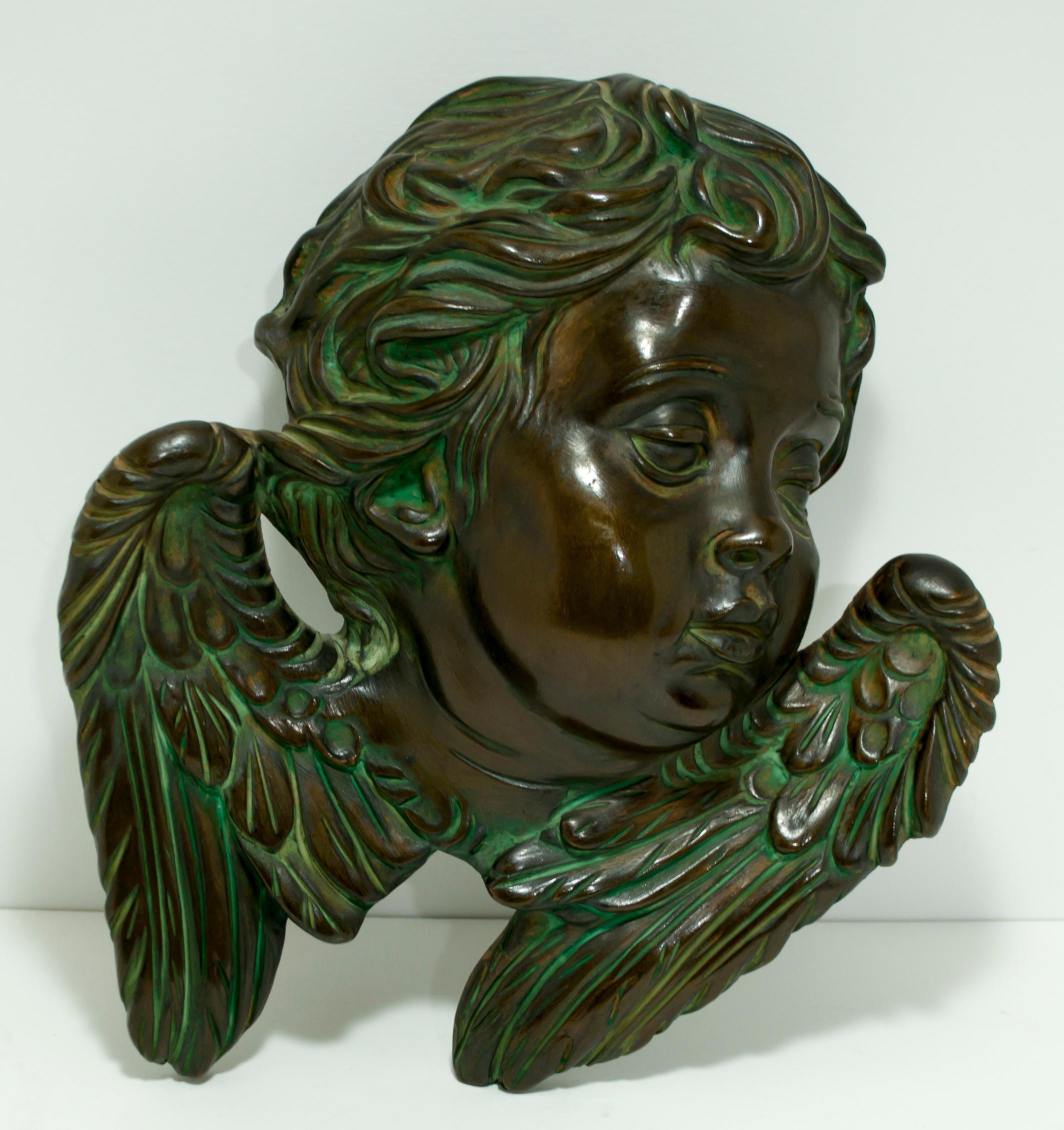 Set of 4 wall cherubs, in majolica ceramic with bronze effect and copper-colored finish, produced and signed by Batignani, Florence, 1950s.