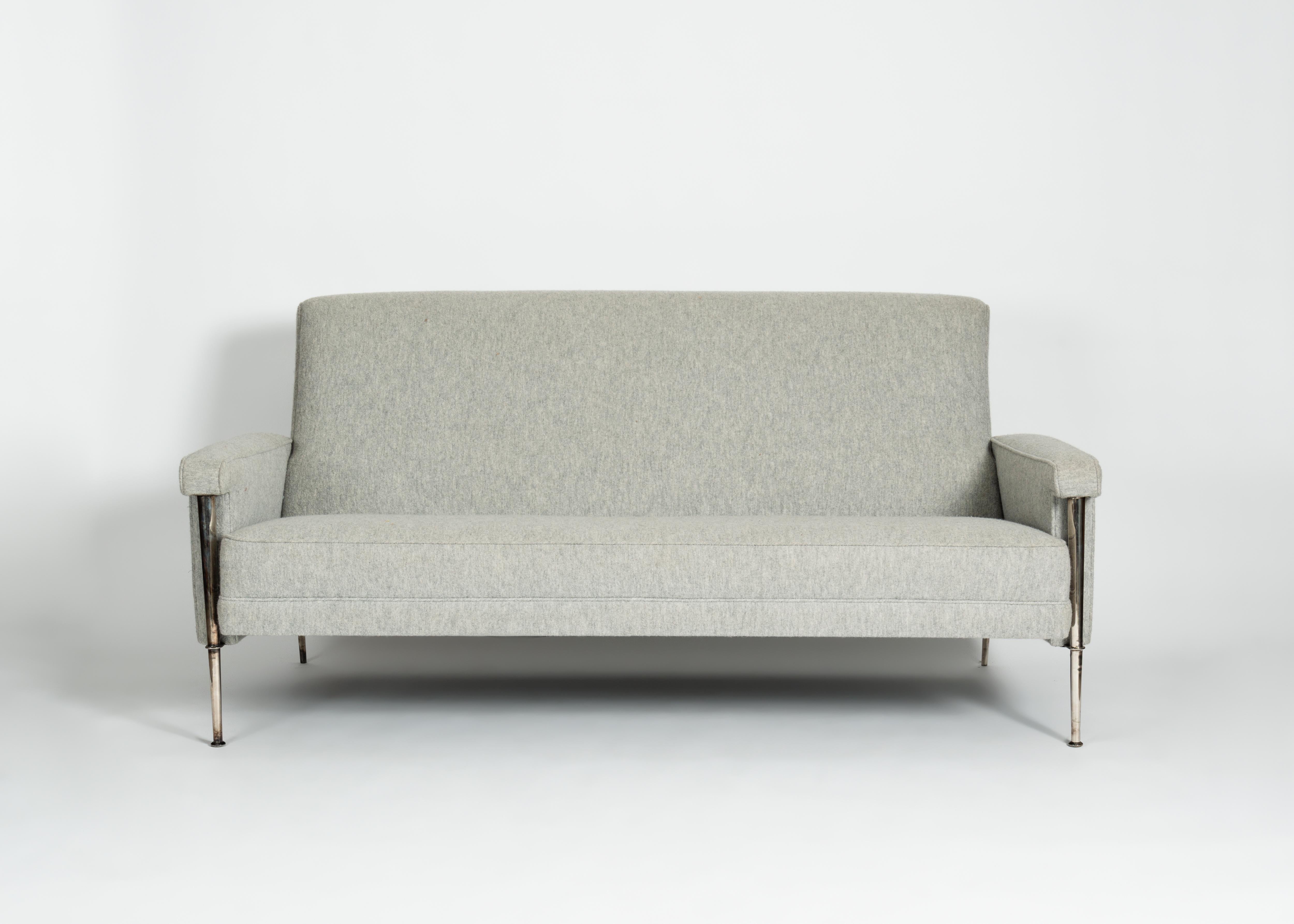 This scaled down midcentury three-seat sofa by Batistin Spade possesses the designer's recognizable thin legs, in this case silvered, and has a broad back set at a charming angle from it's comfortable seat.