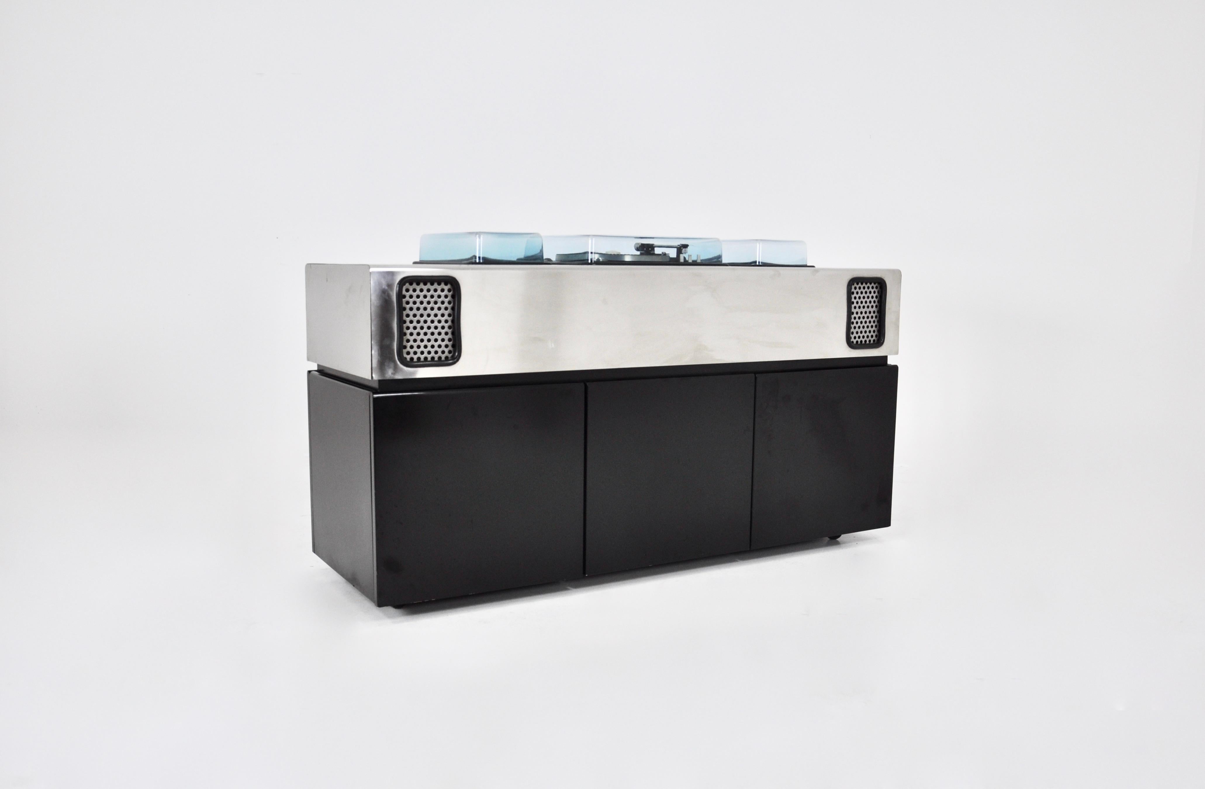 Batman record player, radio and bar by Adalberto dal Lago & Adam Tihany for Giuseppe Rossi. The top is in brushed chrome metal with integrated speakers and the underside in black wood. There are two storage drawers and a fridge in the middle.
