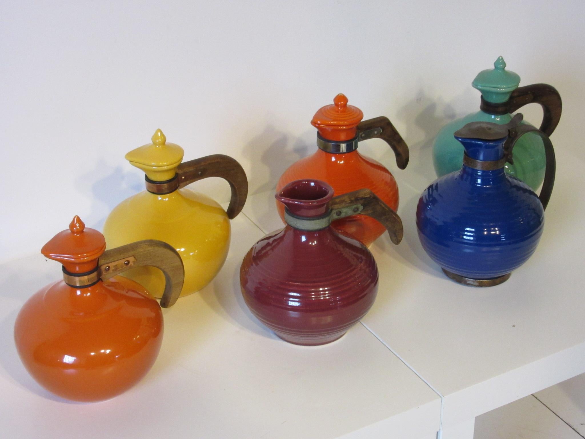 A collection of six coffee pots or carafes by the Bauer pottery company from the Ring Line, noted for their well constructed and wonderful shapes the first to introduce the colorful style which is typically attributed to Fiesta . Great for a touch
