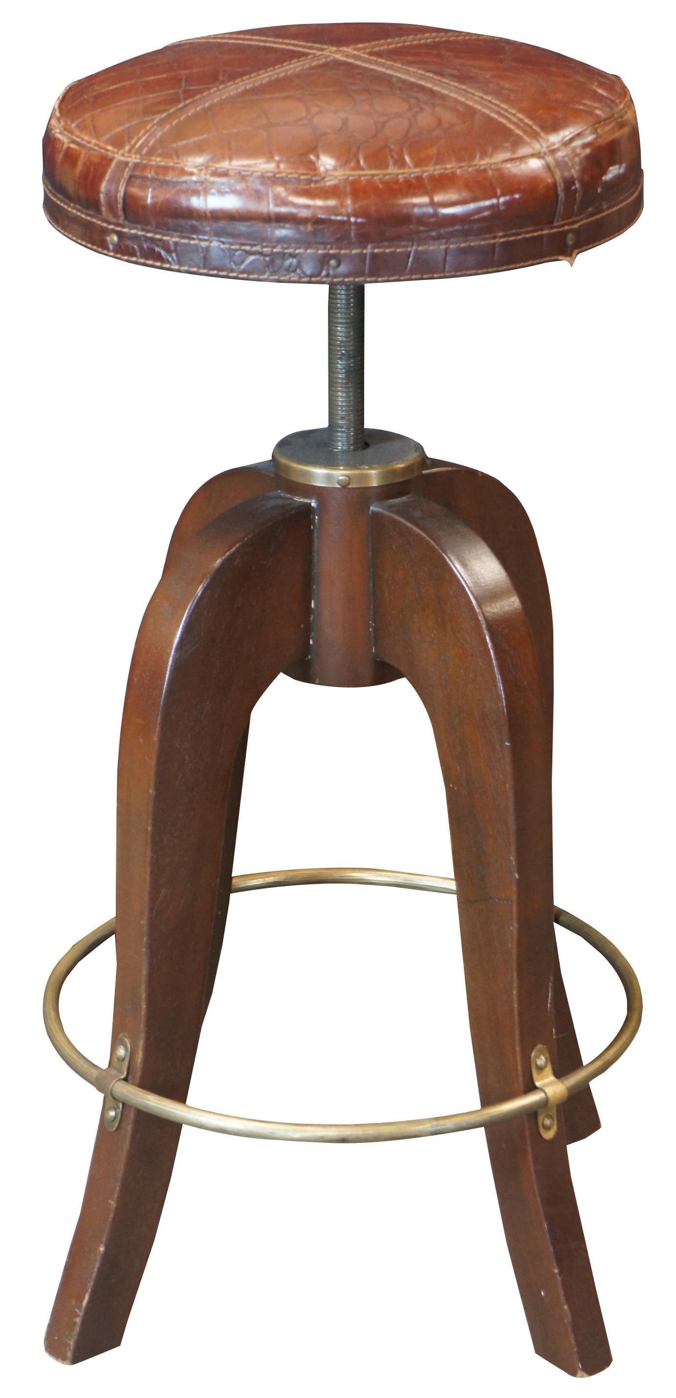 Vintage Bauer International Stiles Brothers collection campaign barstool. Made of mahogany and brass with crocodile embossed leather seat.

About Stiles Brothers Collection - A Spirit of Travel and Adventure
Evoke a spirit of adventure to the far