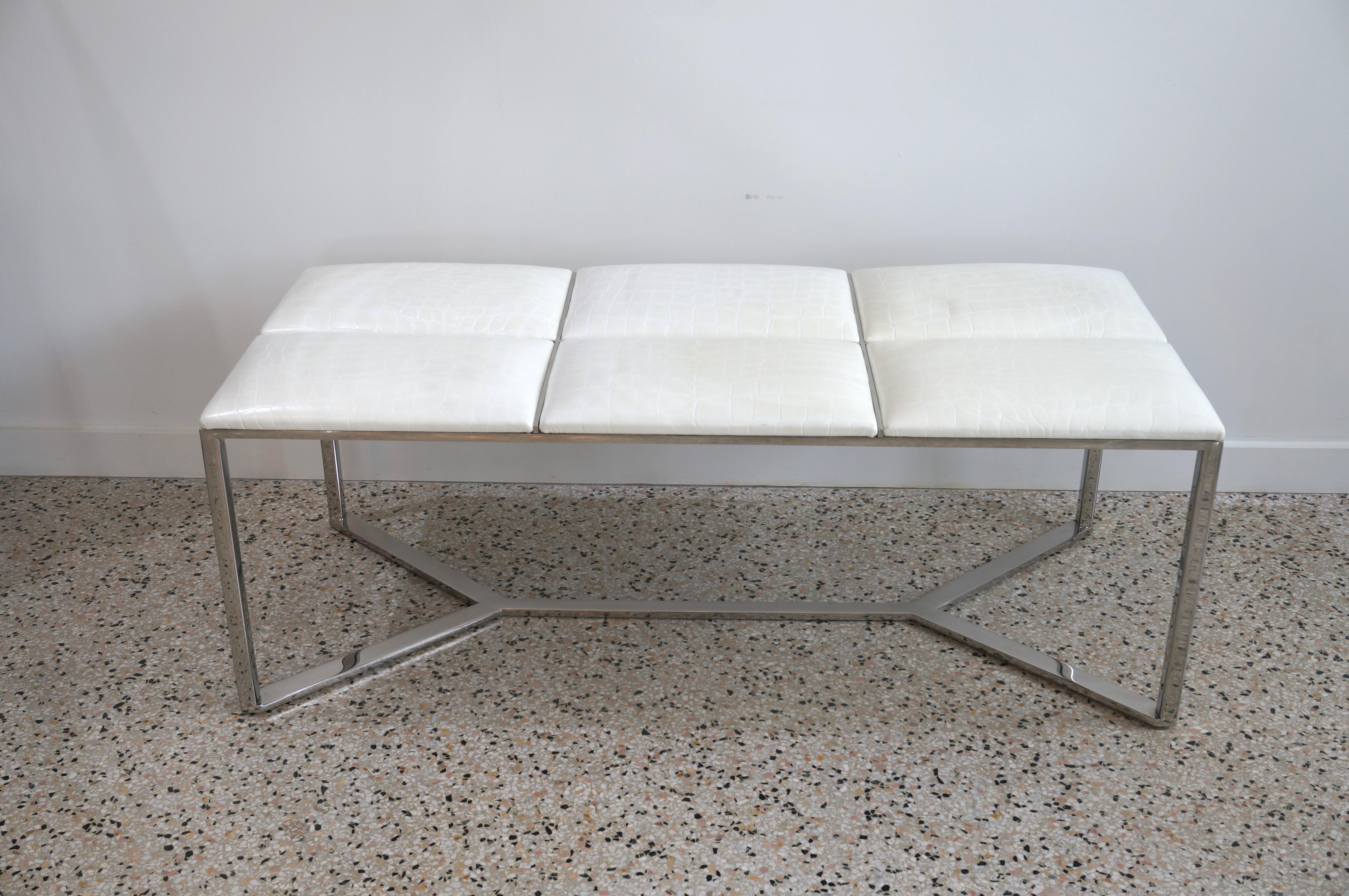This stylish and chic polished steel and leather bench could be used as a cocktail table or at the end of your bed. The leather is an off-white and egg shell colored faux alligator. 

This piece is very much in the style of pieces created by Milo