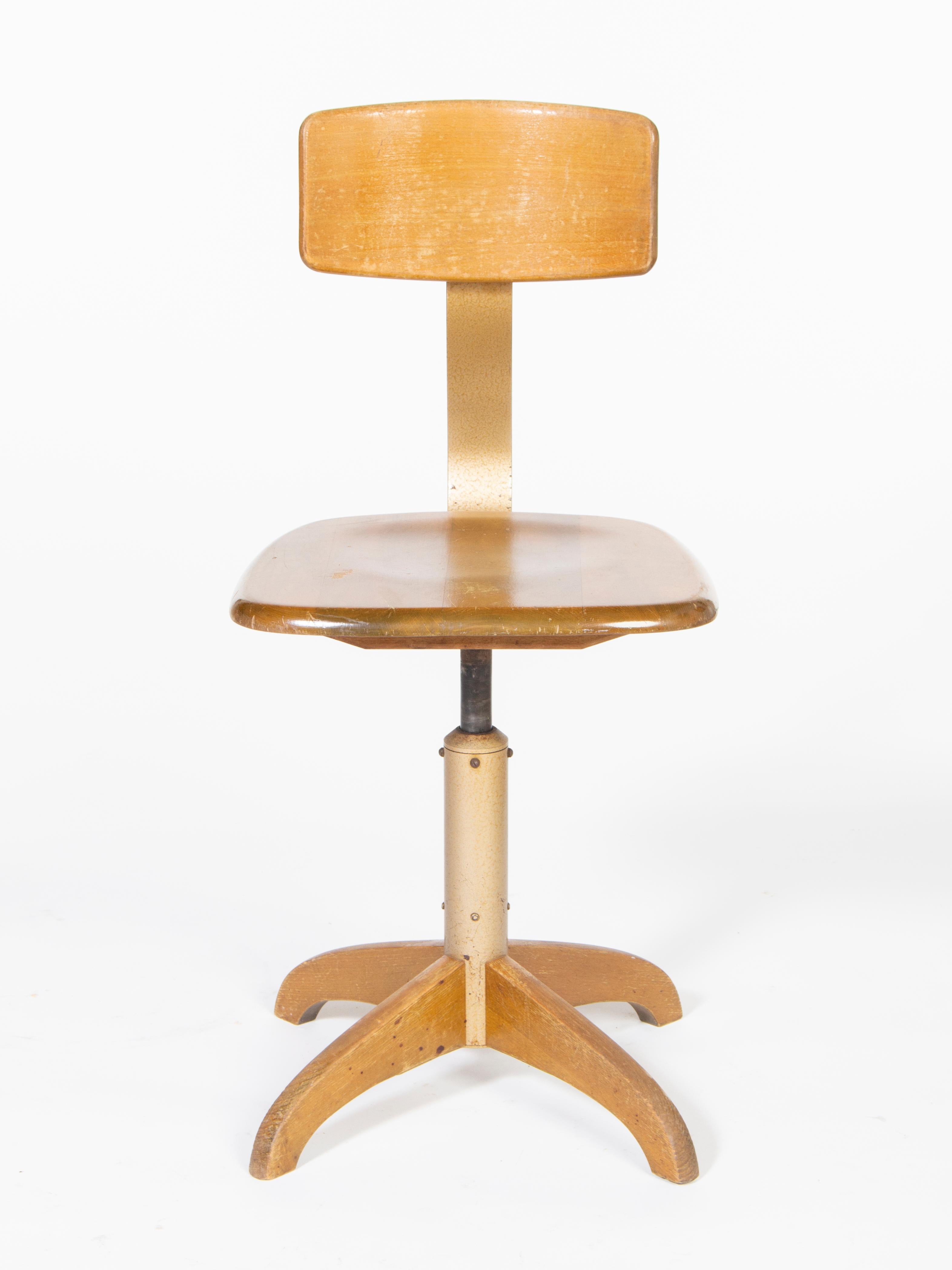 Bauhaus wooden swivel workshop chair.
Manufactured by Ama Elastik, Model number 364.
Adjustable seat height with hydraulic suspension, as well as adjustable leaning height and leaning distance.
 