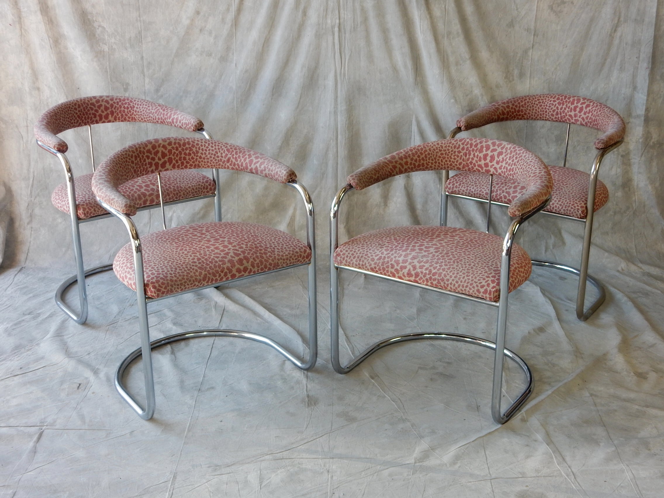 Iconic set of four armchairs designed by Anton Lorenz in the 1920's.
Nickel/chrome plated tubular steel frames upholstered in a soft pink
leopard spot upholstery. Very comfortable.
Upholstery is fair with no holes. Cushions are soft.
Plating on