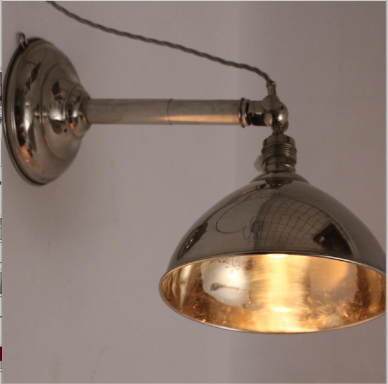 A Bauhaus or art deco era vintage chromed metal table lamp is also usable as a sconce.
Easy to fix on the wall with a hook provided therefore.
Furthermore the stem of the table lamp is adjustable to height and the shiny lamp shade is adjustable from