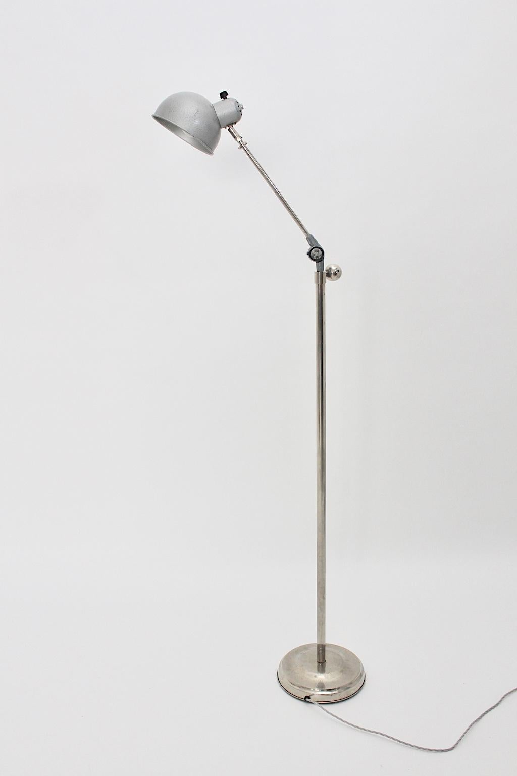 Bauhaus Art Deco nickel metal floor lamp, which is swiveling and adjustable to height from 137 cm to 170 cm.
The floor lamp was made out of nickel plated metal and shows a beautiful patina.
Furthermore the metal lamp shade was grey lacquered.