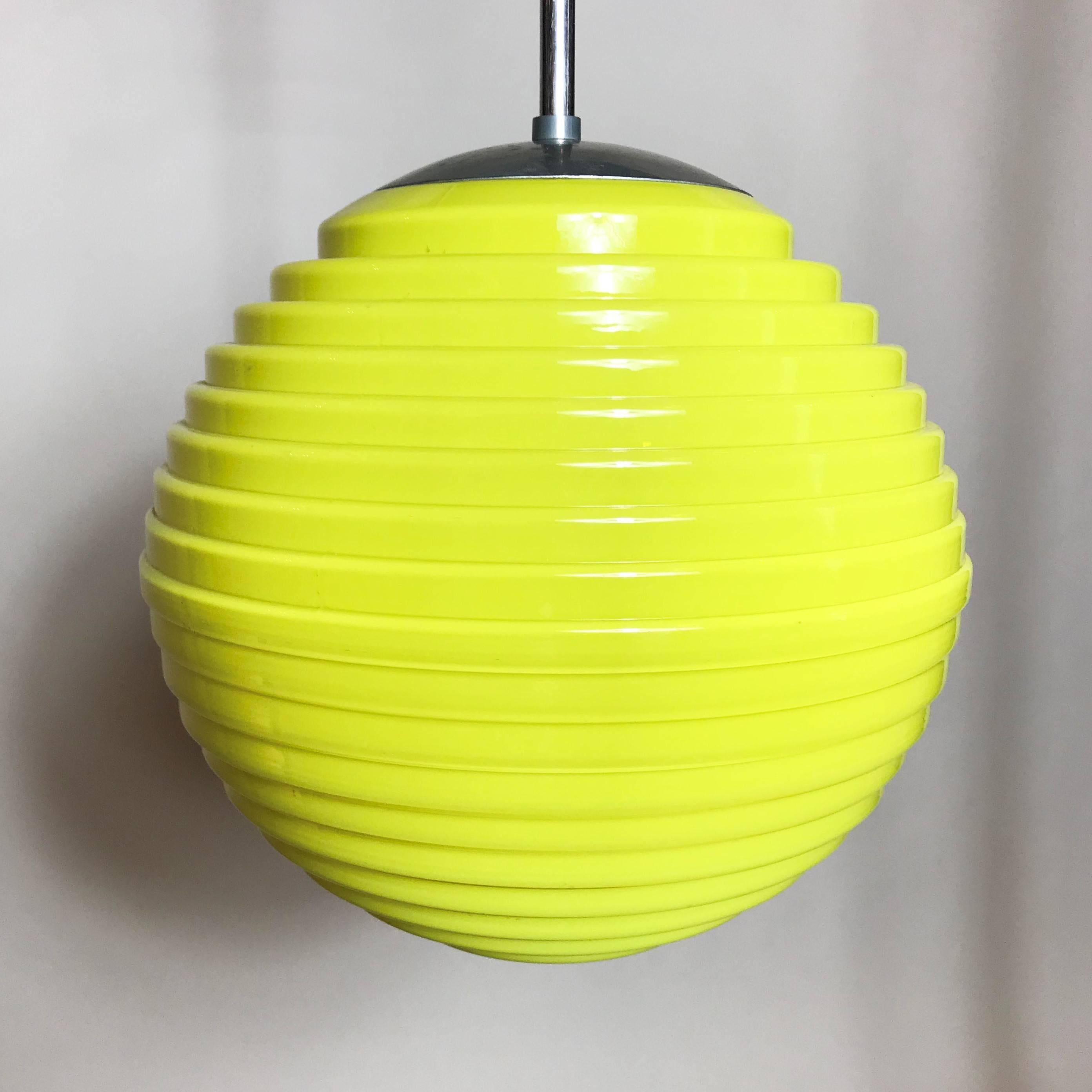 Very unique 1930s beehive pendant lamp. It is characterized by typical Art Deco elements, such as the stepped glass and tulip cable cover, meeting the Minimalist Bauhaus globe lamp design. The lamp is an exquisite example of an era which is