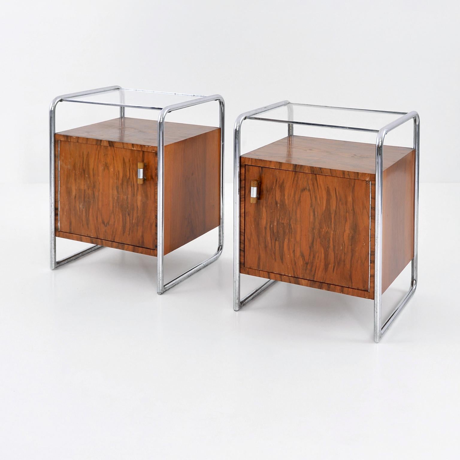 Pair of Bauhaus bedside cabinets, model B 107, designed by J. Fenyves and manufactured by Thonet Mundus A.G. Chrome-plated tubular steel frame, walnut veneer, and glass. Austria, c. 1930.