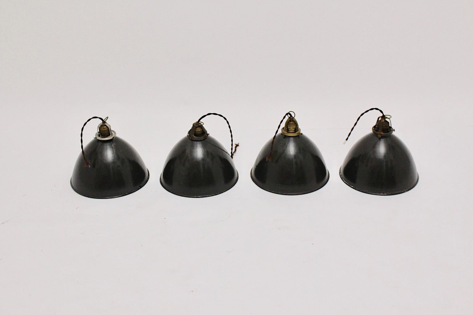 A set of 4 black and white enameled Bauhaus Hanging Lamps, which were designed and executed 1920s in Europe, Germany. 
The simple and clean Industrial Design features make it easy to go with each design style.

The hanging lamps were made out of