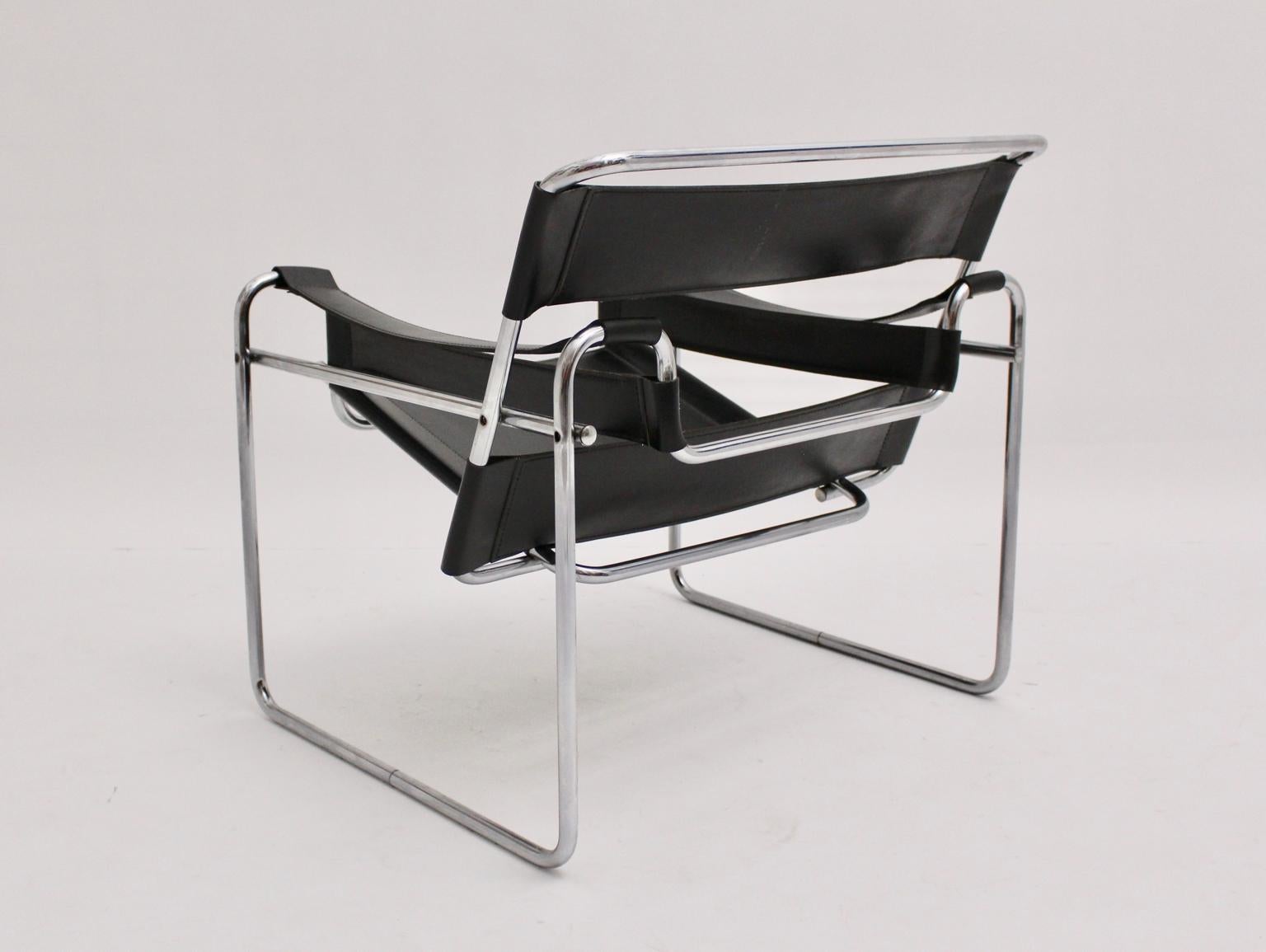 Bauhaus vintage tube steel lounge chair with black leather model Wassily was designed by Marcel Breuer 1925 - 27 and probably executed in Italy circa 1970. There are no manufacturer hallmarks. 
The black leather shows great patina, while the metal