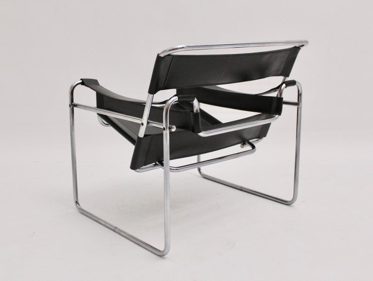 Bauhaus vintage tube steel lounge chair with black leather model Wassily was designed by Marcel Breuer 1925 - 27 and probably executed in Italy circa 1970. There are no manufacturer hallmarks. 
The black leather shows great patina, while the metal