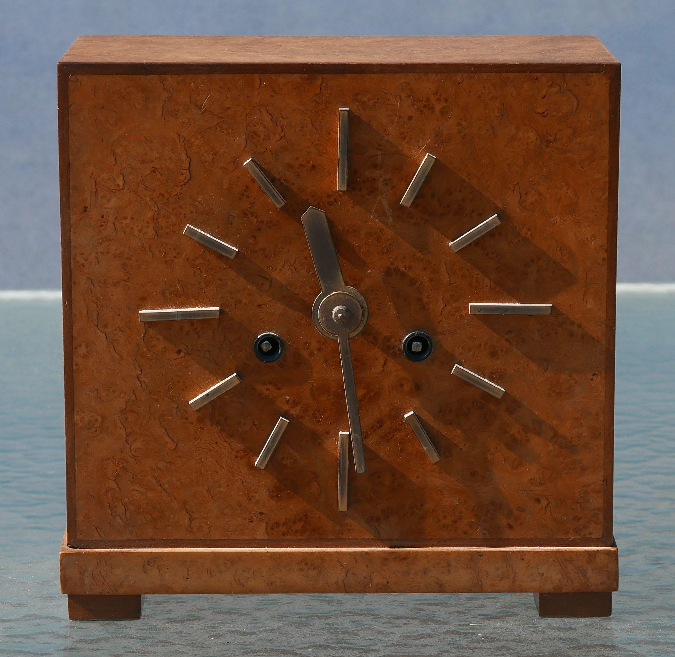 Beautiful Burled case with walnut trimmed edges and brass hands and indices. 8 day clock with a beautiful movement accessible from the back, both the movement and the chime can be wound from the front. Clock can be used with or without the chime.