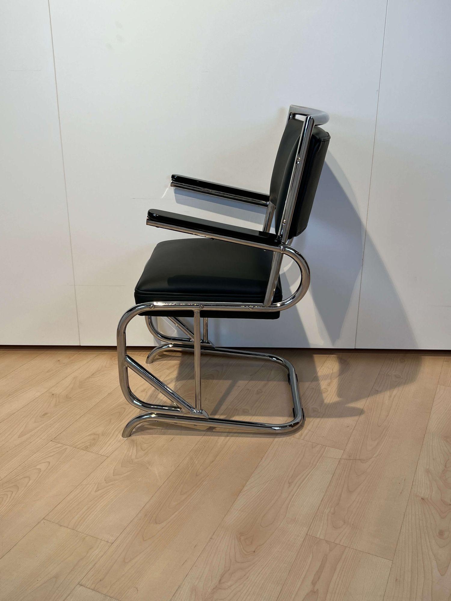Bauhaus Cantilever Armchair, Chromed, tubular steel, Leather, Germany circa 1935.

Frame completely new chrome-plated. Armrests black high gloss lacquered. Newly upholstered with black leather and keder.
Manufacturer: probably Mauser Waldeck