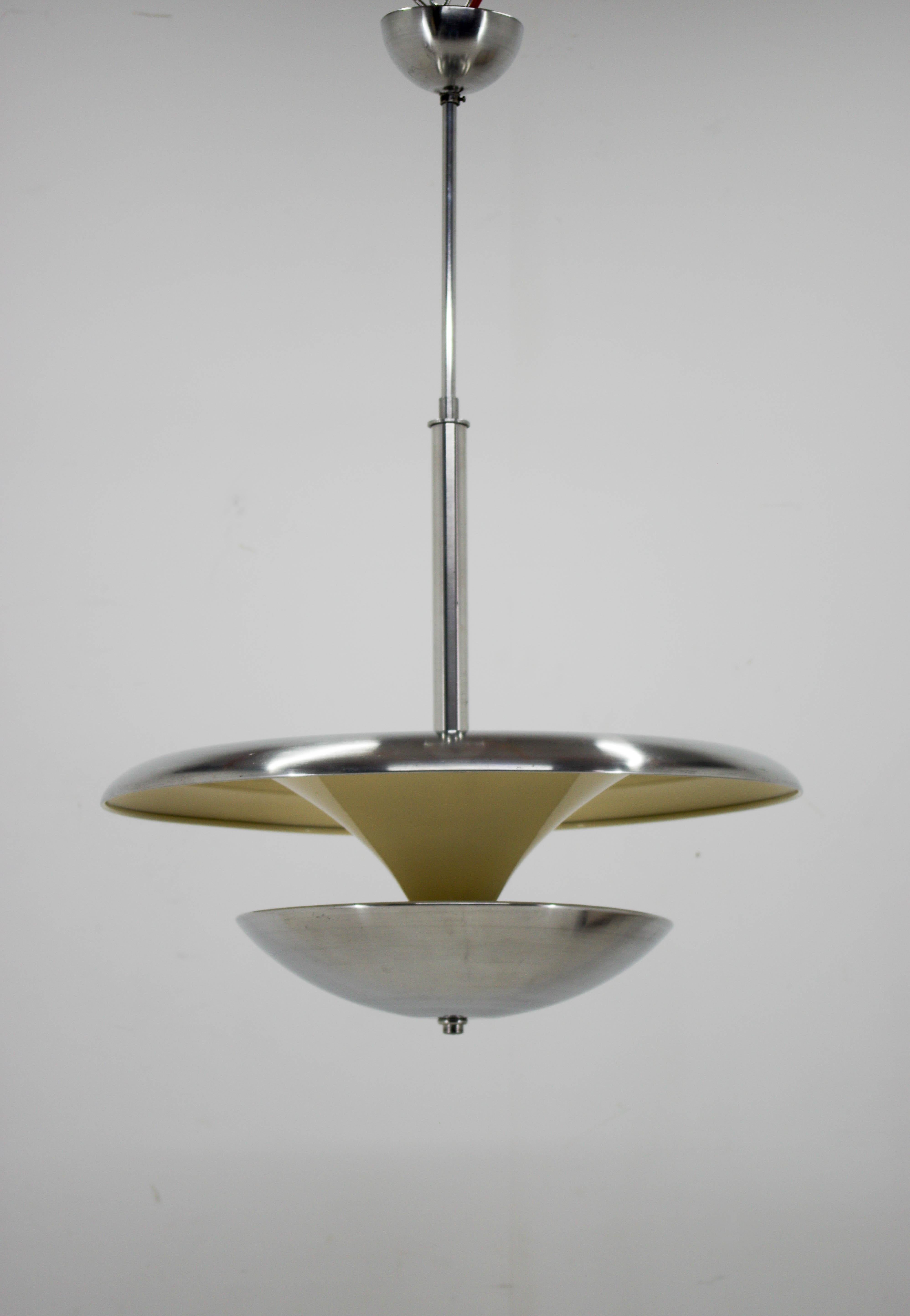 Rare Bauhaus aluminum chandelier made by IAS in 1930s.
Two items available
Restored, new ivory paint, polished, upper plate with minor scratches, bottom plate without any deformations.
Rewired: two separate circuits: 2+3x40W, E25-E27 bulbs. 
US