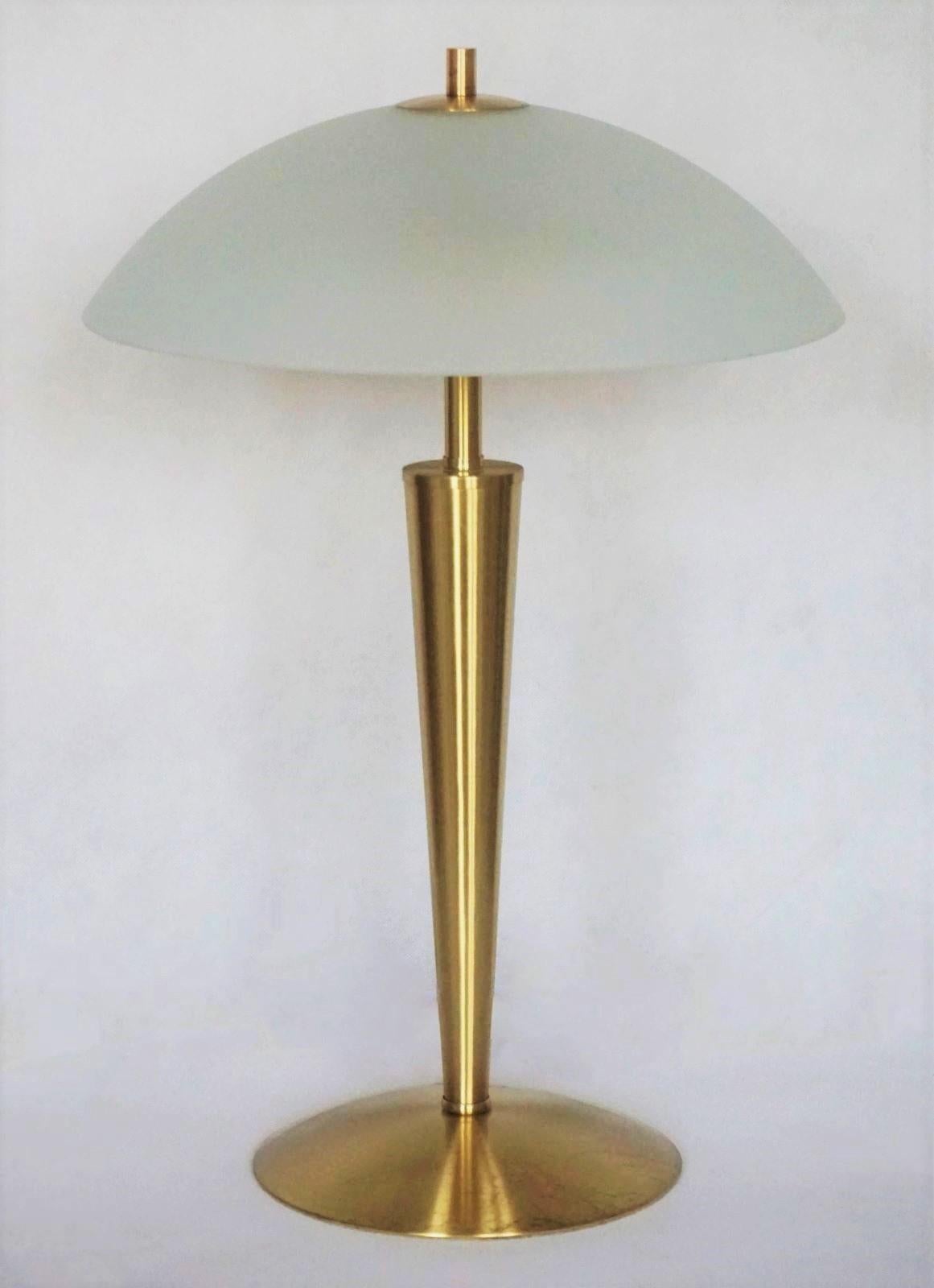 Bauhaus two-light table lor desk Lamp, Germany, 1960s. These high quality table lamp is of chased brass with satin finish glass shade. 
Thsi lamp is fully functional and in good condition, 
It takes two E14 light bulbs. 
Measures: Height 19