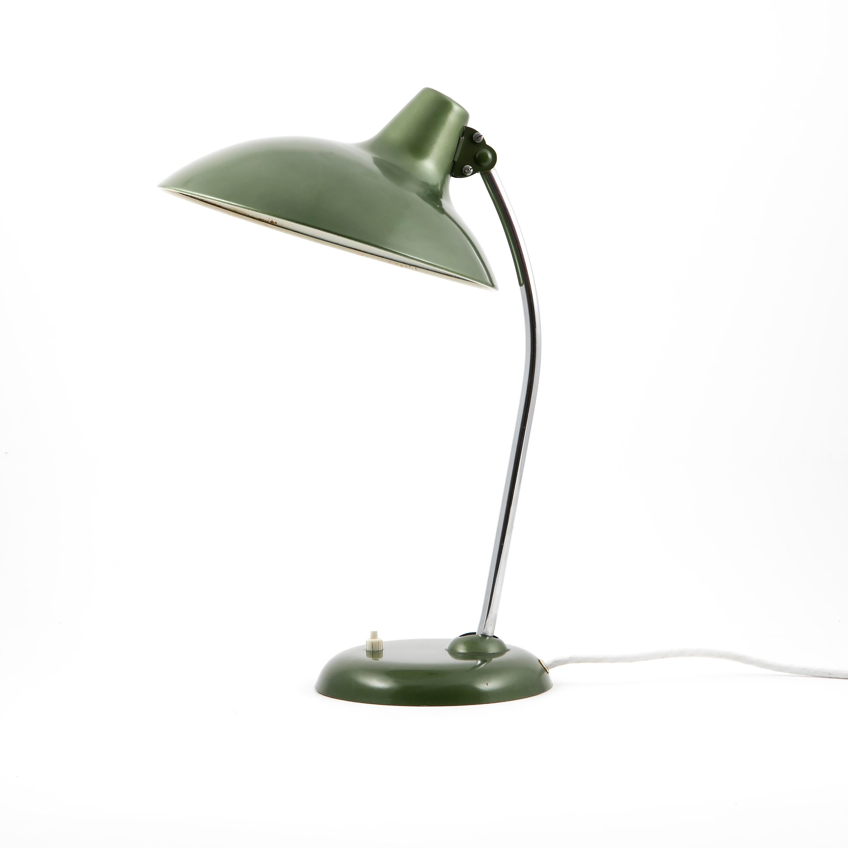 Bauhaus Christian dell desk lamp model 6786 for Kaiser Idell, Germany.
Chromed arm and adjustable metal shade in metallic emerald green.
Lightswith located on base. New cloth-covered wire.
Great original vintage condition.
Germany 1950's