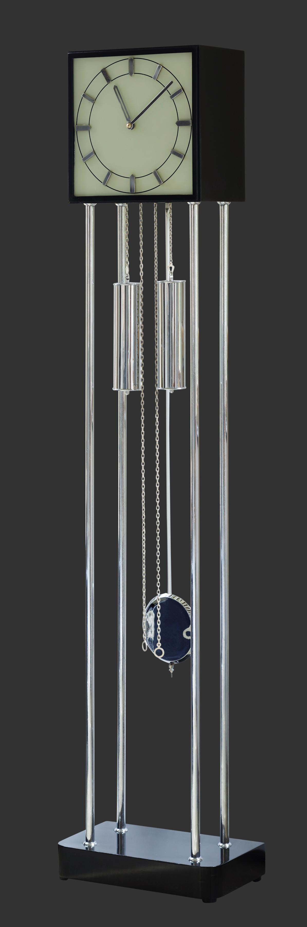 ‘Bauhaus’ Chrome Longcase Clock

Chrome and ebonized longcase clock resting on a heavy ebonised base with four chrome tubular pillars supporting a square pediment with a glass dial with raised chrome baton numerals.

Eight day German weight