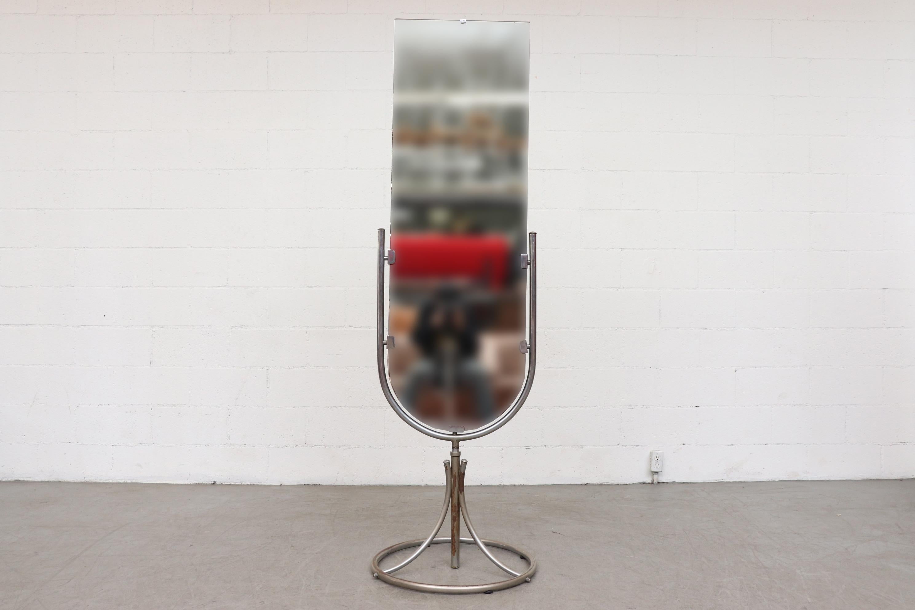 Bauhaus chrome-plated swivel standing double sided mirror with circular base. New made mirrors in original frame with very visible signs of wear, including loss to chrome plating on metal base and visible surface rust. All consistent with age and