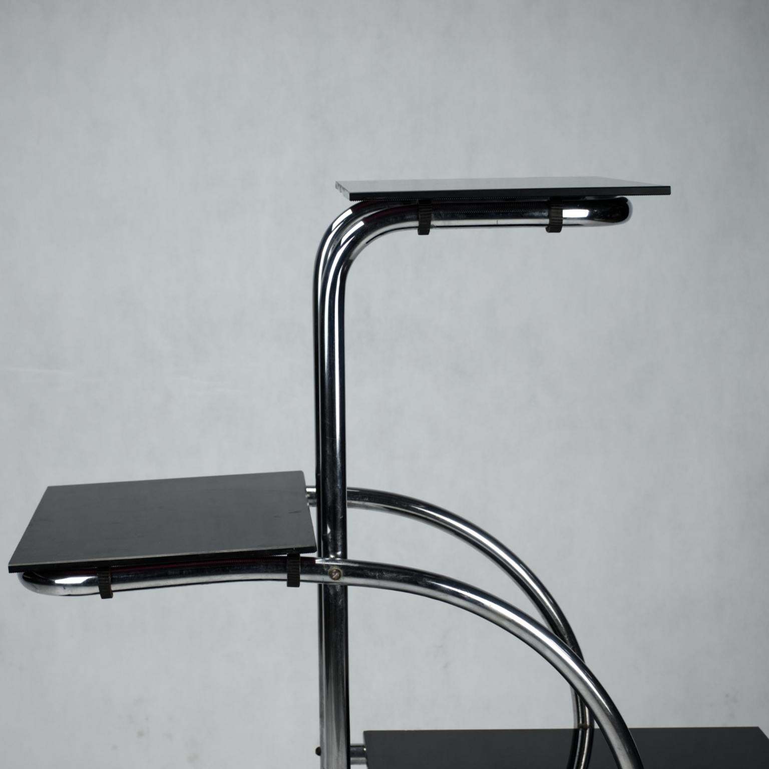 Chrome-plated tubular steel étagère designed by Emile Guyot and made in the 1930s with opaxite glass shelves. Chrome plating is in original condition.