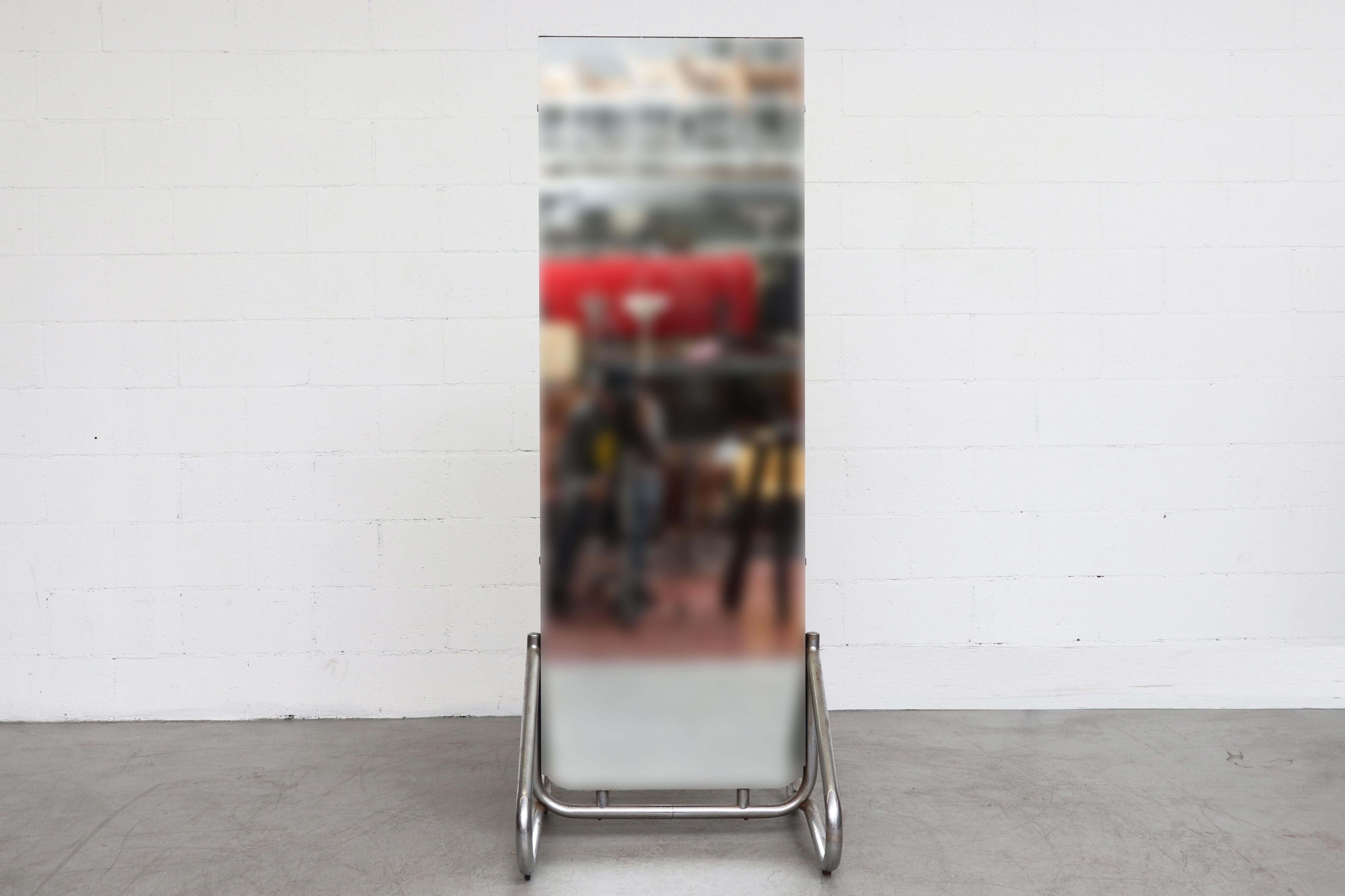 Chic Bauhaus chrome standing mirror. Black painted wood backing. In very original condition with visible signs of wear including patina to chrome base. Visible scratching to the frame and chipping to the mirror. Wear is consistent with its age and