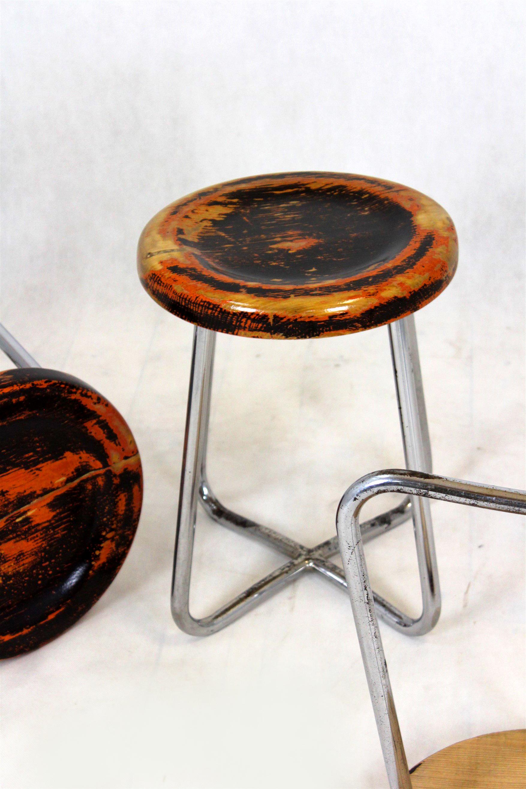 A set of three Bauhaus style stools, manufactured in the 1930s by Robert Slezak in Czechoslovakia. Made of wood and chromed tubular steel. Preserved in good, original condition, with a visible patina. The seats have been lacquered, to protect the