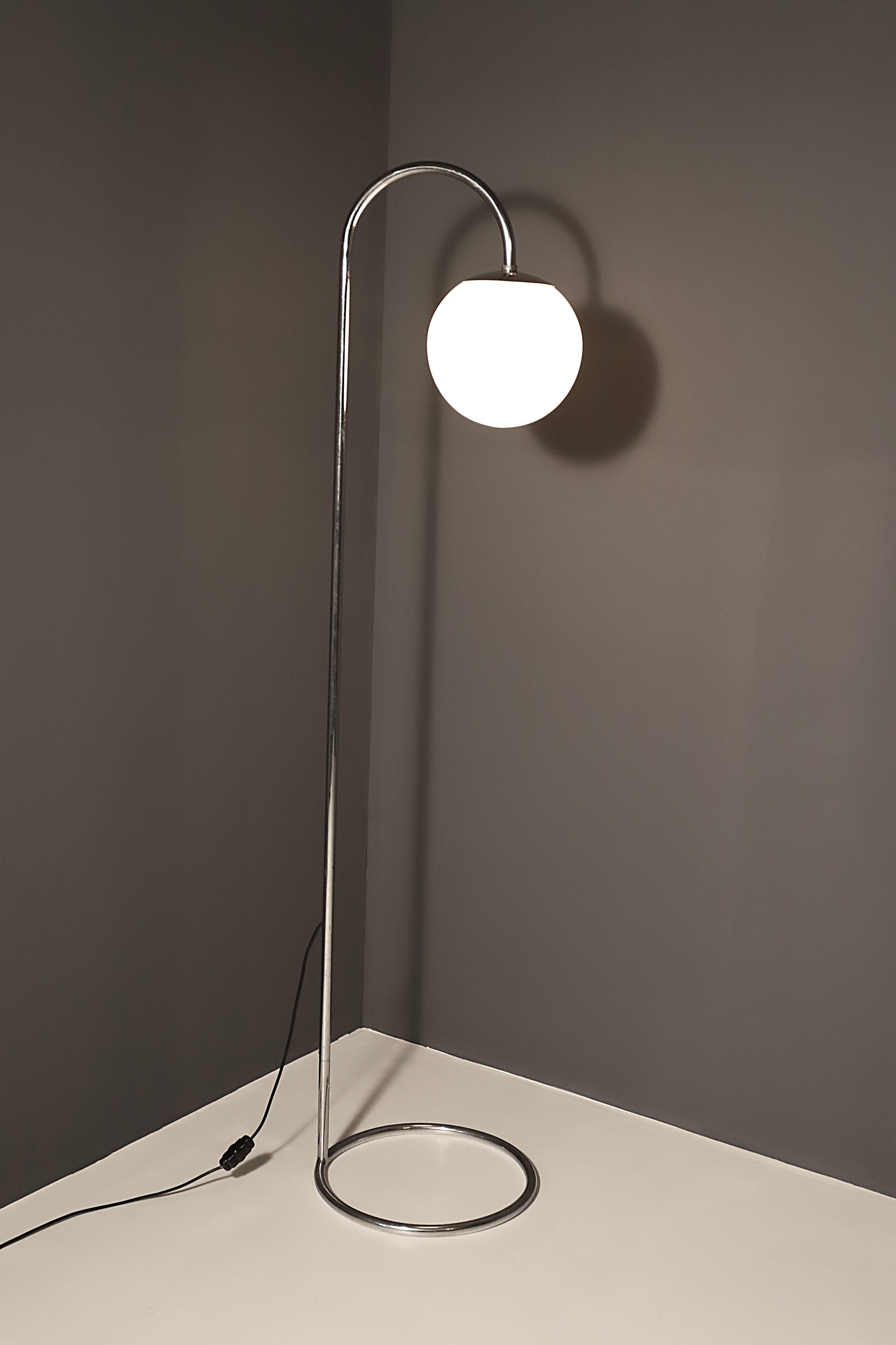 This chromed floor lamp was designed and made in the former Czechoslovakia in the 1930’s. It’s made of chromed-plated steel with milk glass shade.
The simple shape of the lamp is related to the Bauhaus period when minimalist shapes entered applied