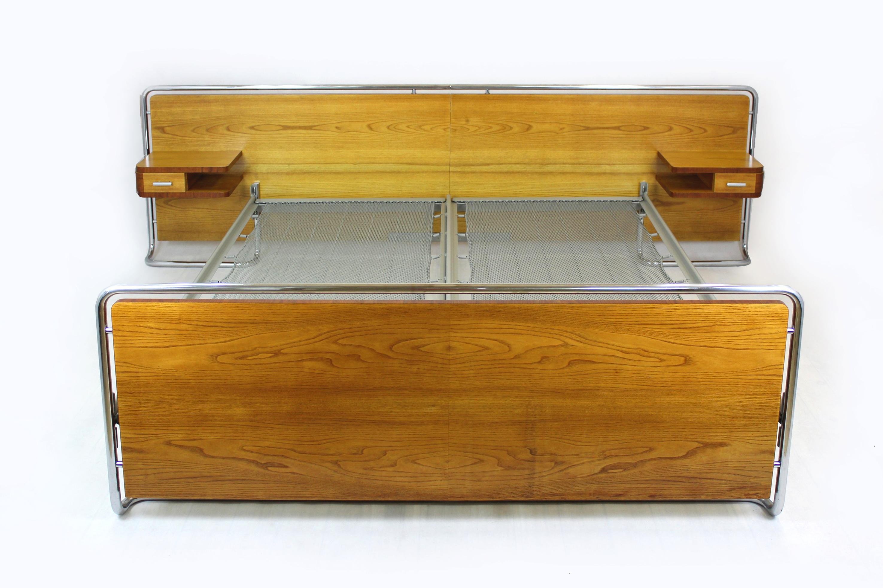This Bauhaus style bedroom set was produced by Rudolf Vichr in the 1940's in Czechoslovakia.
The set consists of a double bed, two suspended bedside tables and a dressing table with a mirror. The furniture is veneered with two types of wood - ash