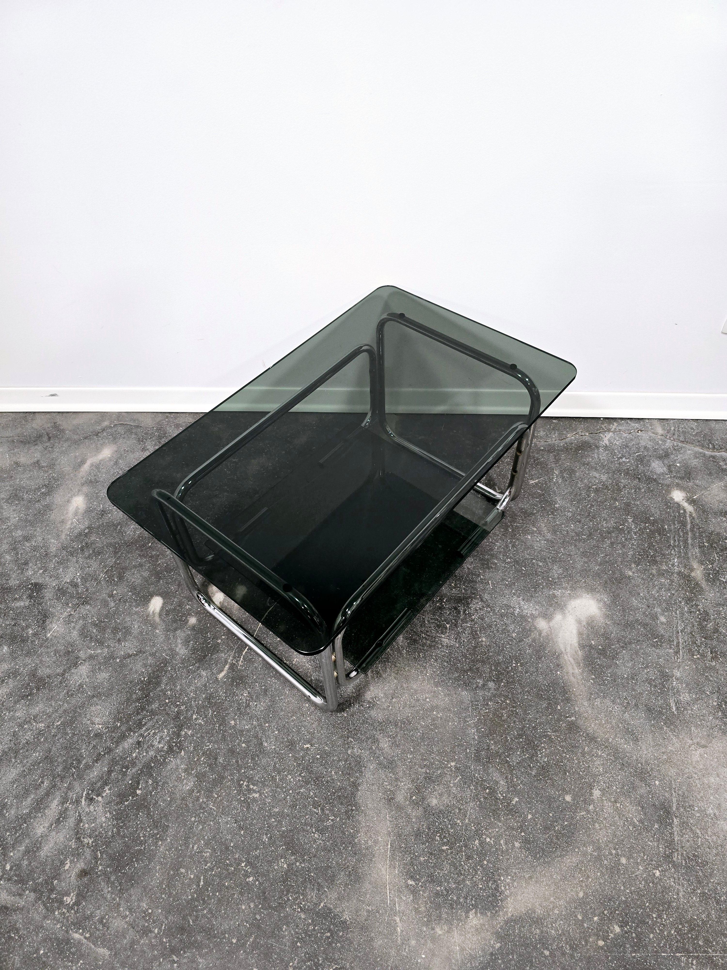 Coffee table, tubular metal structure in the bauhaus style of the 70s Italy. Thick smoked glass top in very good condition. Pipes are produced in light weight and sturdy.

Table dimensions:
- width 67cm;
- depth 48cm;
- height 40,50 cm (lower shelf