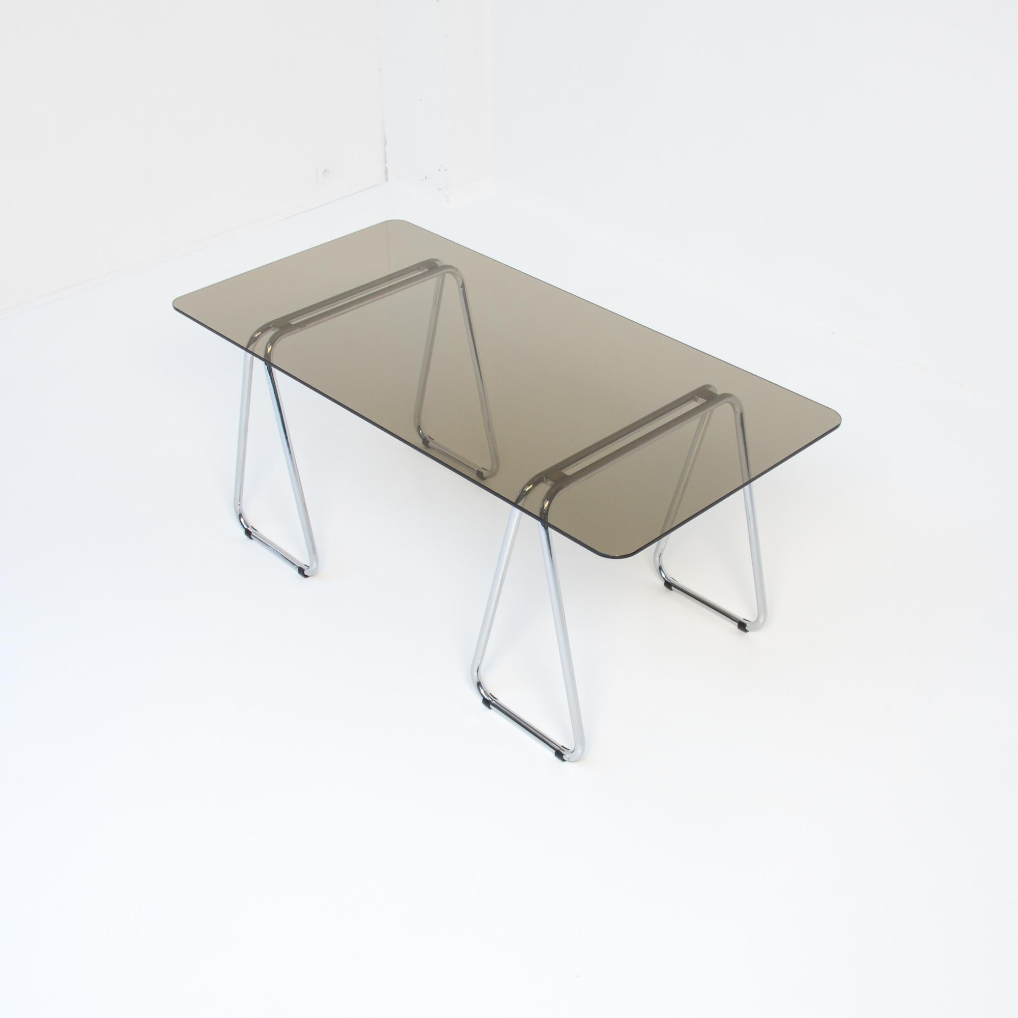 This rare drafting table or desk was designed by Marcel Breuer in 1926. This one is produced by Gavina in the 1960s.
The trestles are made of chromed metal and the tabletop is made of brown smoked glass.
It is a very rare piece and a beautiful set