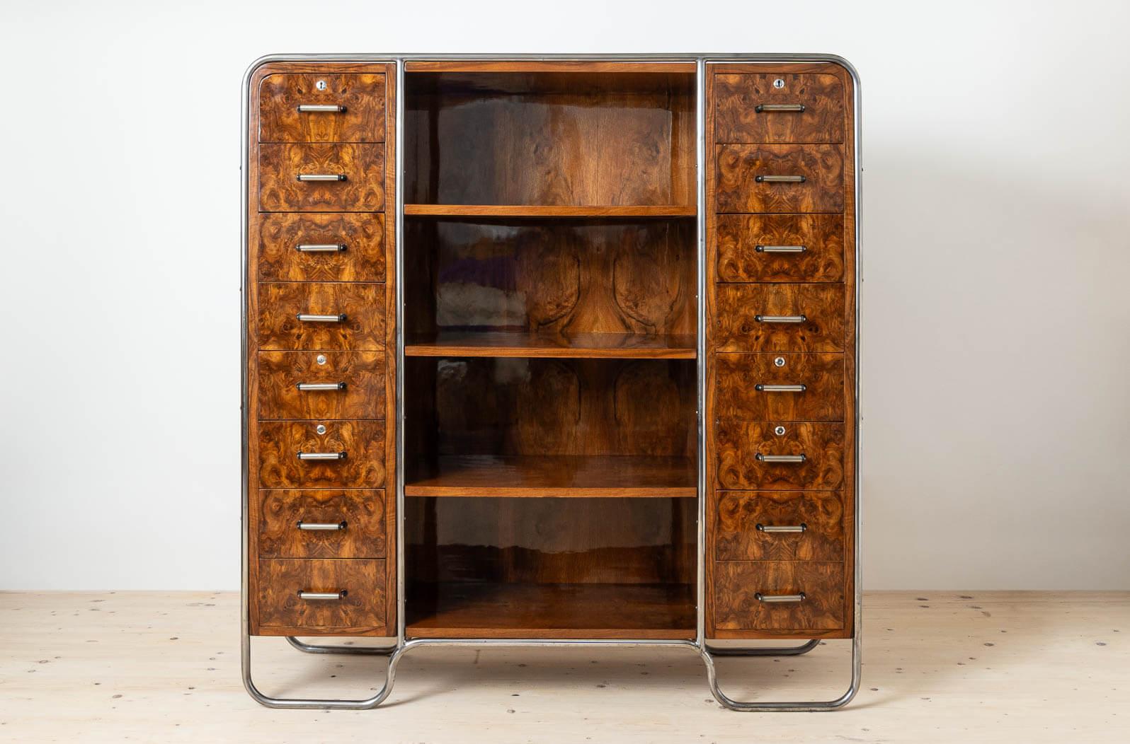 This stunning Bauhaus era bookcase was made around 1930s, most probably in Italy. It features gorgeous tubular steel frame in one piece that embraces wooden chest with shelves and drawers, a perfect blend of esthetic design and function. The