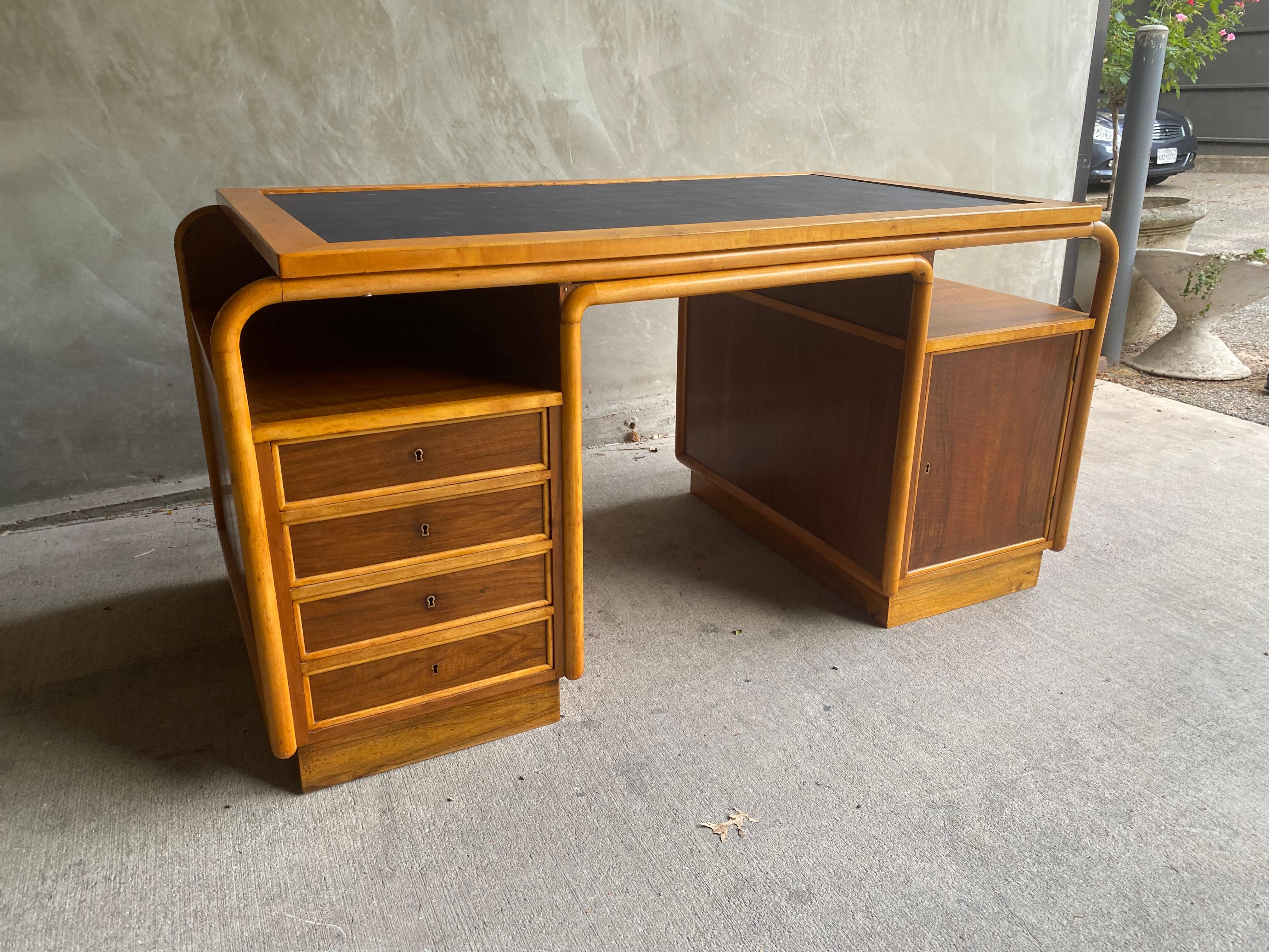 Bauhaus era kneehole desk with Thonet style bentwood frame. Solid maple trim with inset panels of book matched European walnut veneer. Finished on all sides with inset faux ink black leather writing blotter surface. Eastern Europe, 1930's.