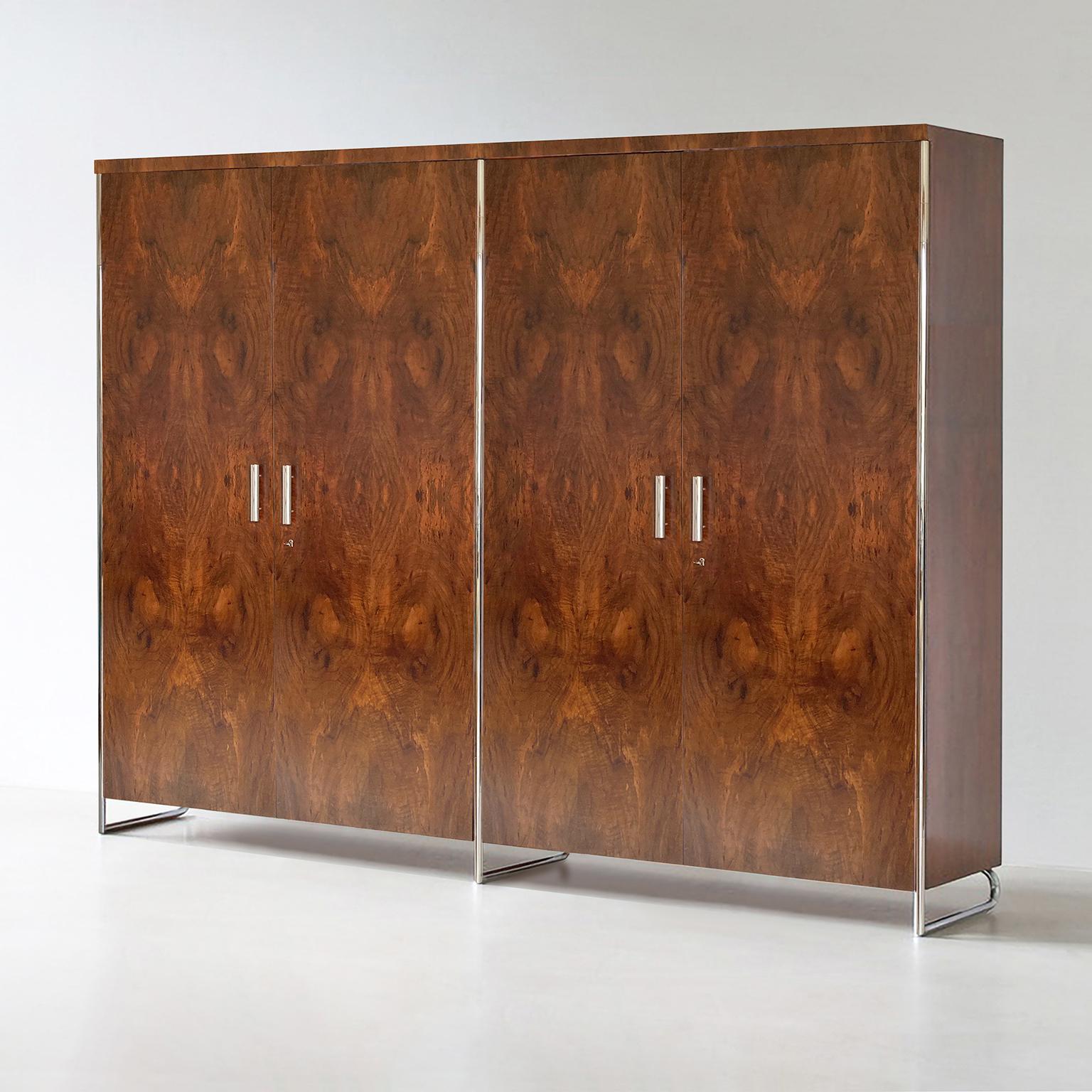 Made-to-measure Bauhaus wardrobe designed by Hermann John Hagemann and Manufactured by GMD Berlin. The four door wardrobe is made of chrome plated metal and walnut veneer.