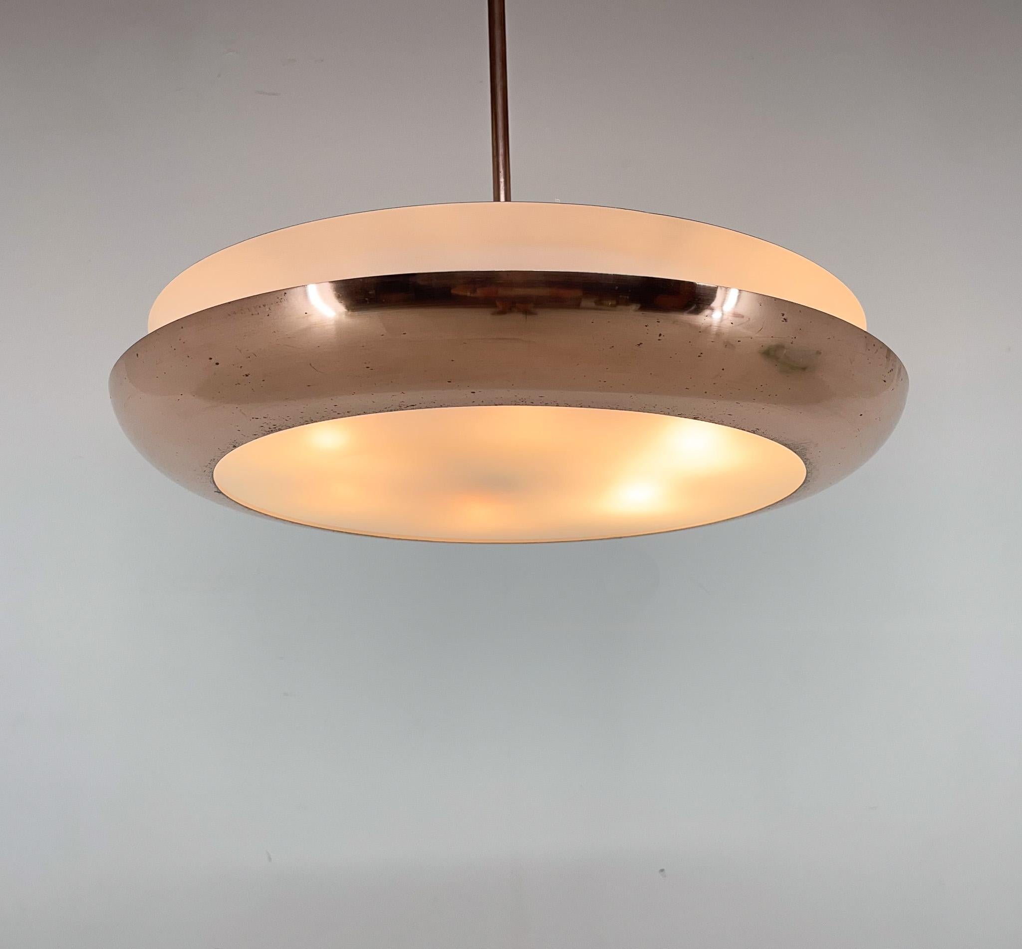 Beautiful copper and metal pendant light designed by famous Josef Hůrka for Napako in former Czechoslovakia in the 1940's. 
Restored.
Rewired:6x60W, E25-E27 bulbs. 
Central rod can be shortened on request. 
US wiring compatible.