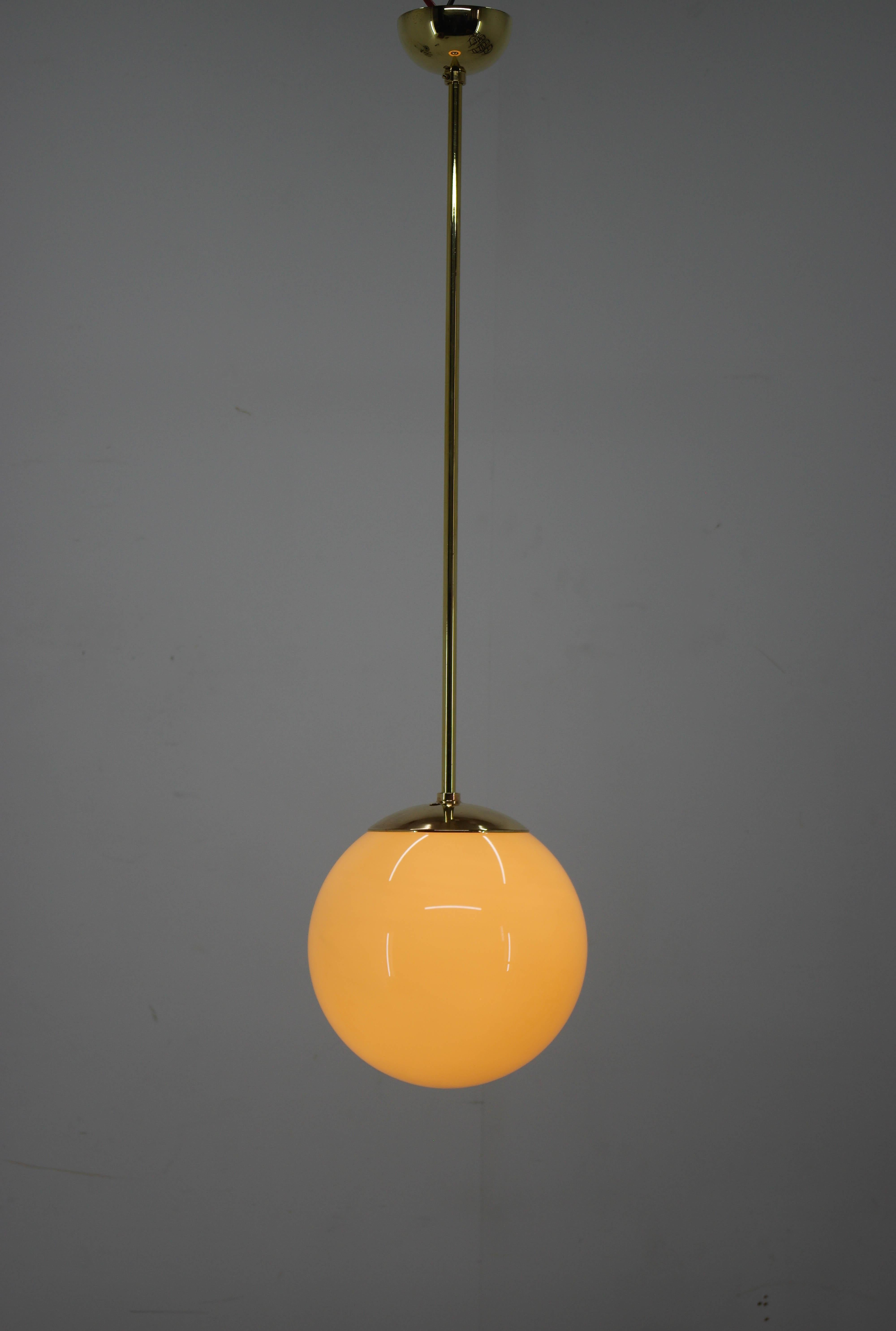 Simple Bauhaus/Functionalist brass and blown glass pendant.
Restored, brass polished, rewired - 1x60W, E25-E27 bulb
US wiring compatible