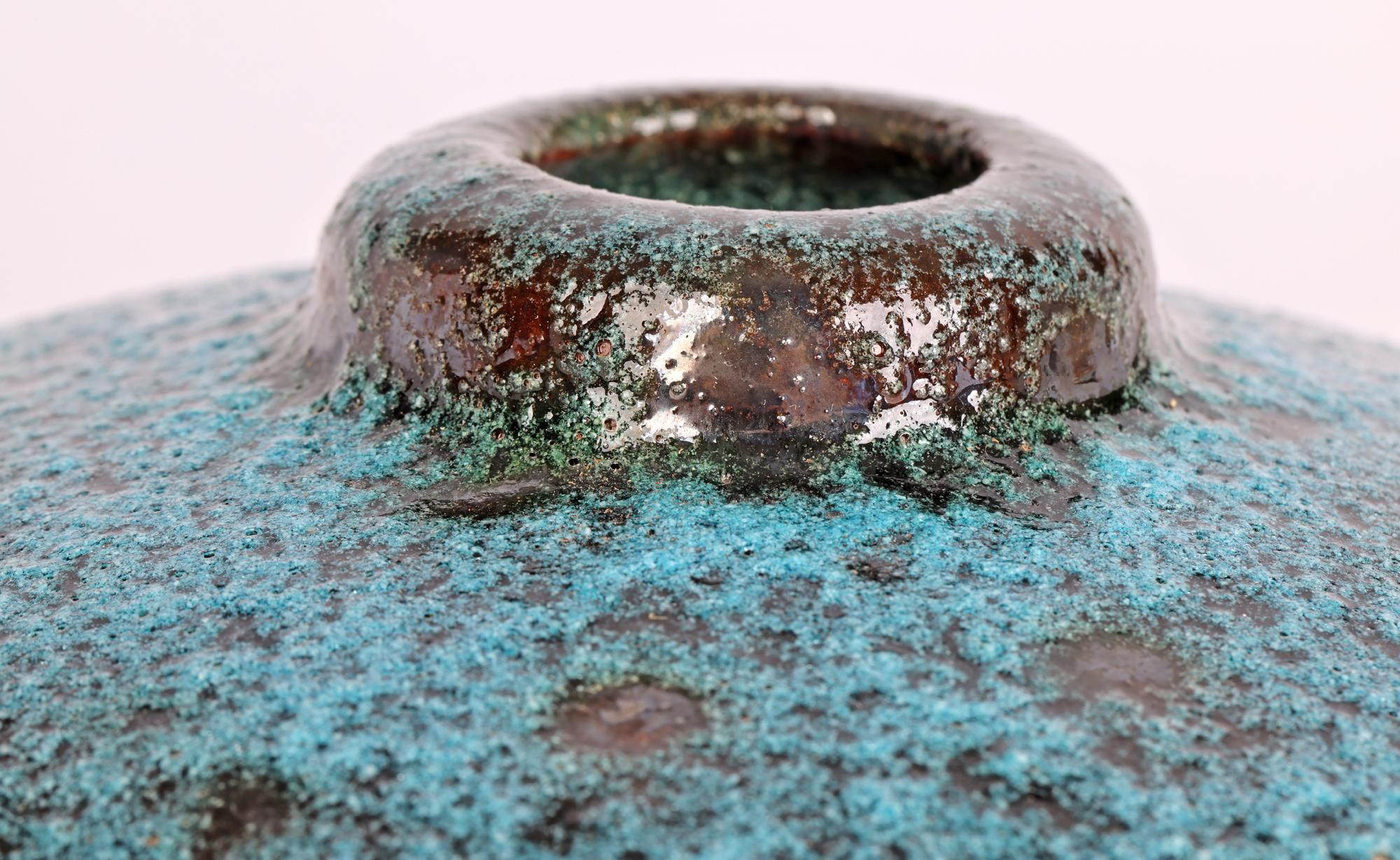 A very stylish Art Deco Bauhaus attributed modernist vase decorated in blue textured glazes dating from the 1930/40’s. The vase of squat wide rounded shape stands on a flat metallic glazed base with small narrow raised round opening, the body