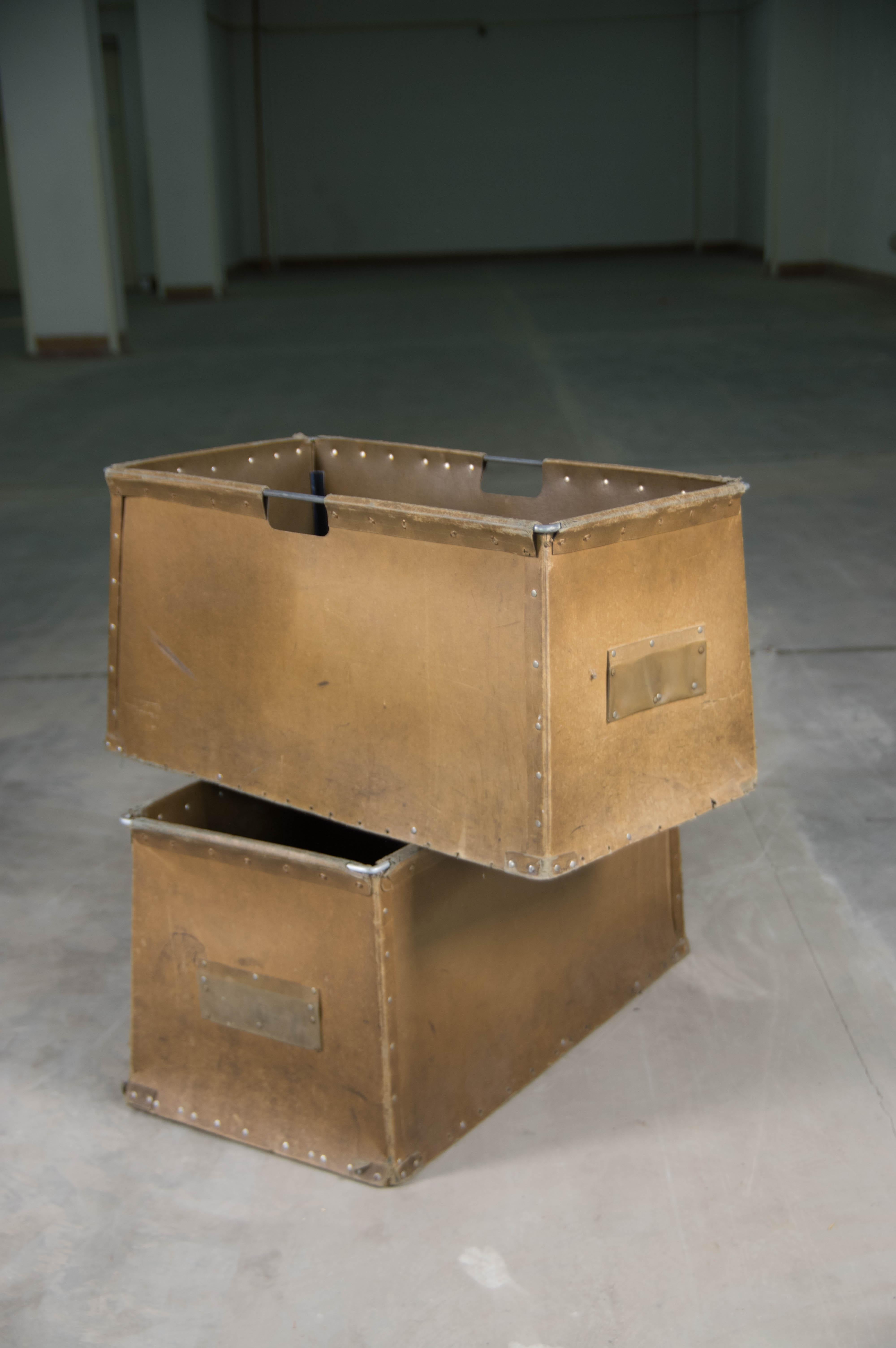 Storage and transport boxes made in the 1930s and used for almost a century in a textile factory. The lightweight and practical construction consists of steel wire and hard, strong paper boxes. They were designed for carrying lightweight textile