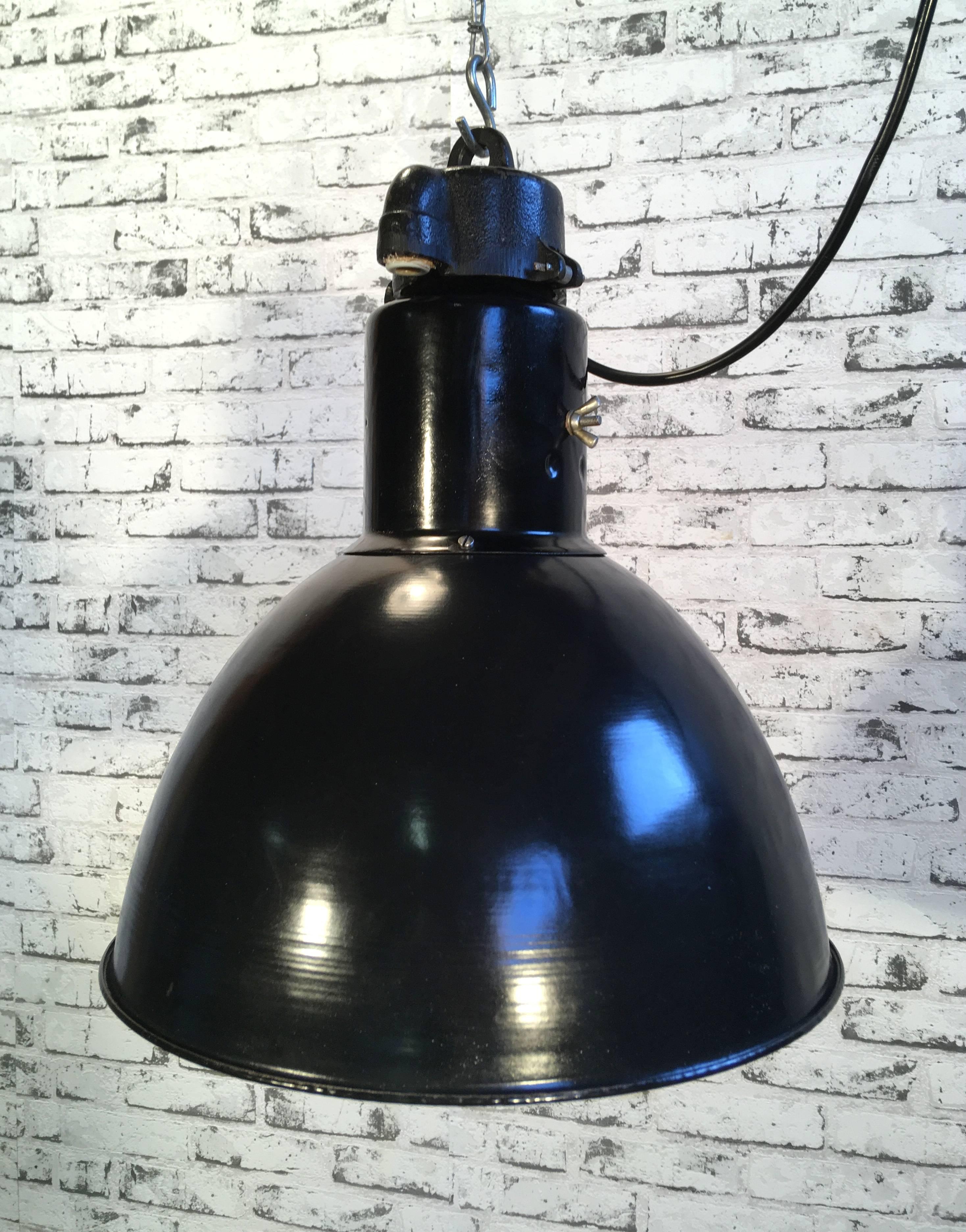 - Black enamel pendant lamp 
- Made by Elektrosvit in former Czechoslovakia
- Bauhaus style 
- Designed in the 1930s 
- White enamel on the inside 
- Cast iron top 
- New socket E 27 and wire.