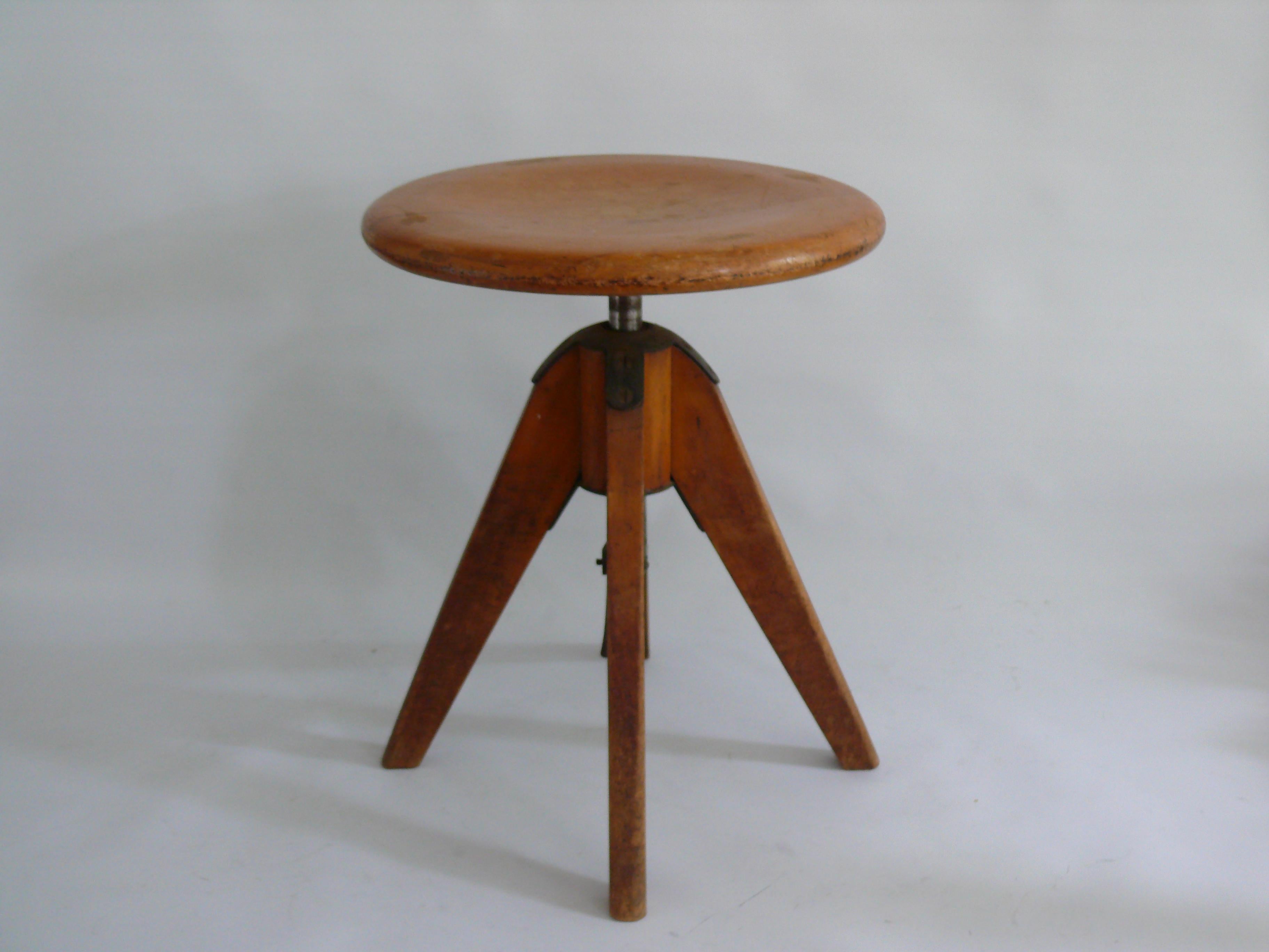 Un tabouret pivotant inhabituel/un tabouret d'atelier de construction robuste, probablement des années 1930 : Le tabouret repose sur quatre pieds effilés, maintenus par une pièce métallique qui abrite également la broche en métal. Cette broche est