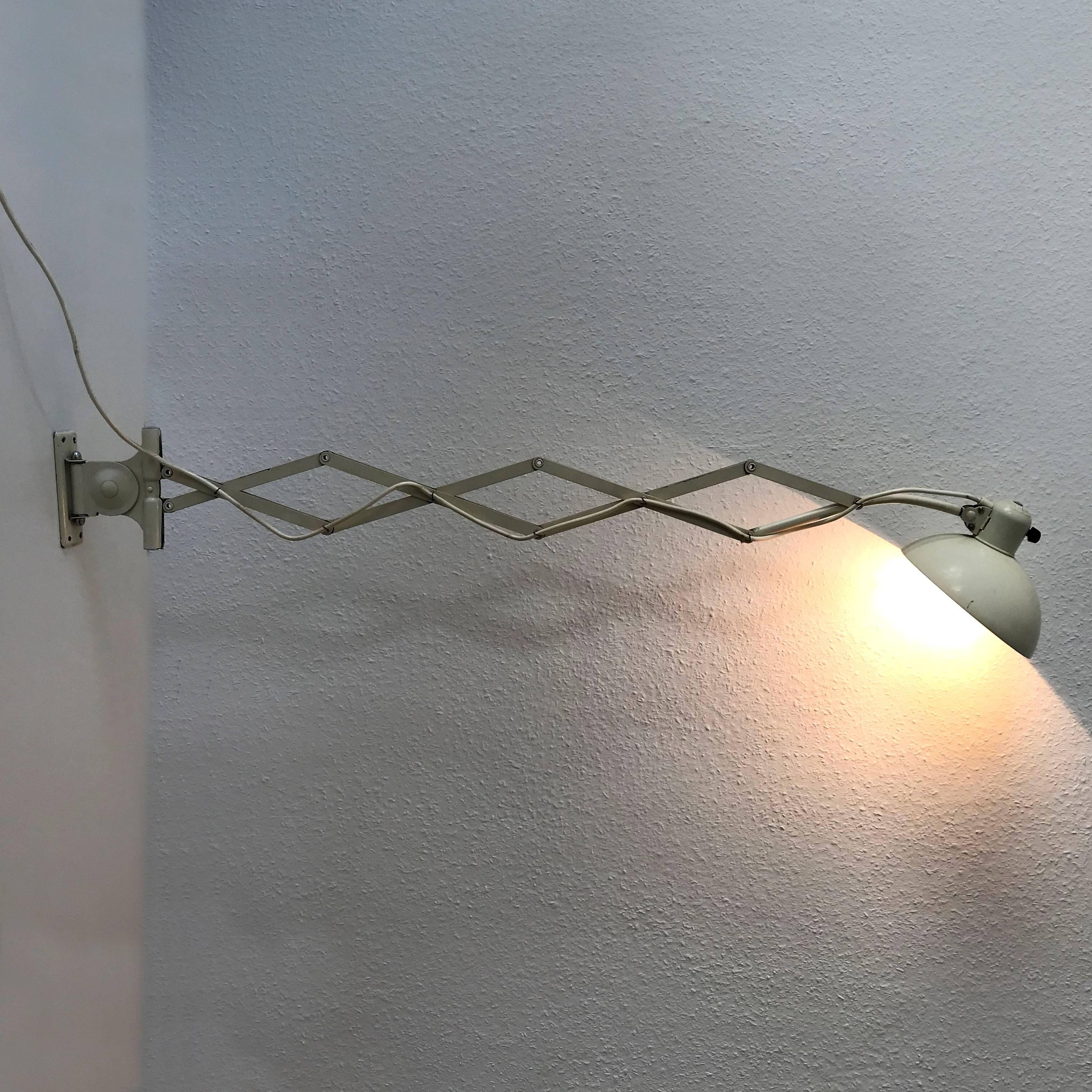 Huge and articulated Bauhaus Kaiser Idell scissor wall lamp. Model 6614 / 122. Designed by Bauhaus work master Christian Dell in 1930s for Kaiser Leuchten GmBH, Neheim-Hüsten, Germany. The lamp is produced in 1950s-1960s by Kaiser Leuchten (with