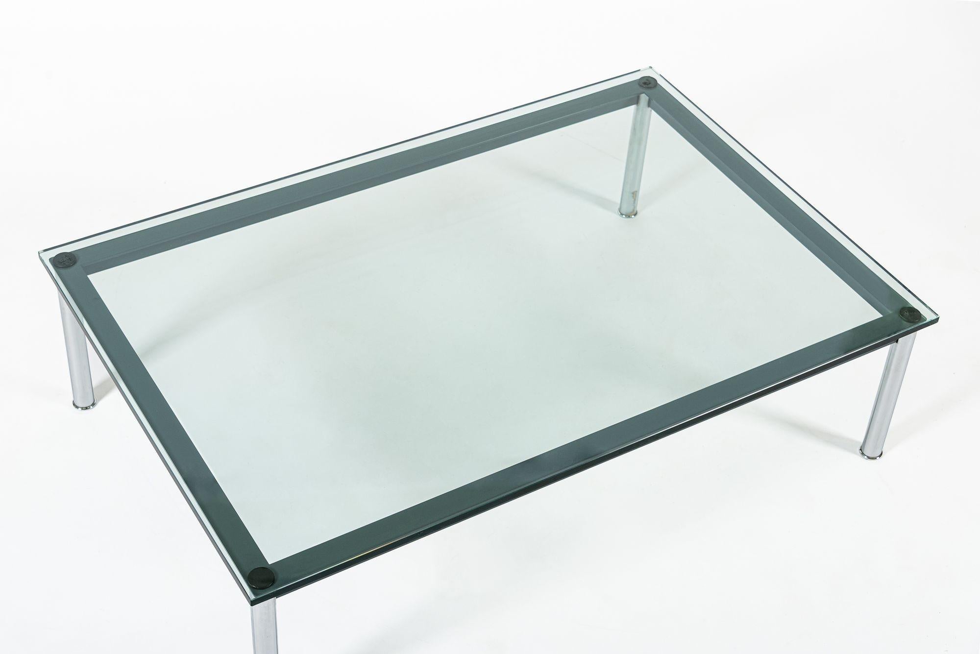 This classic Bauhaus LC10-P steel and glass low coffee or cocktail table was designed by Le Corbusier, Charlotte Perriand and Pierre Jeanneret and first exhibited at the Salon d’Automne in Paris in 1929. Le Corbusier referred to a house as a