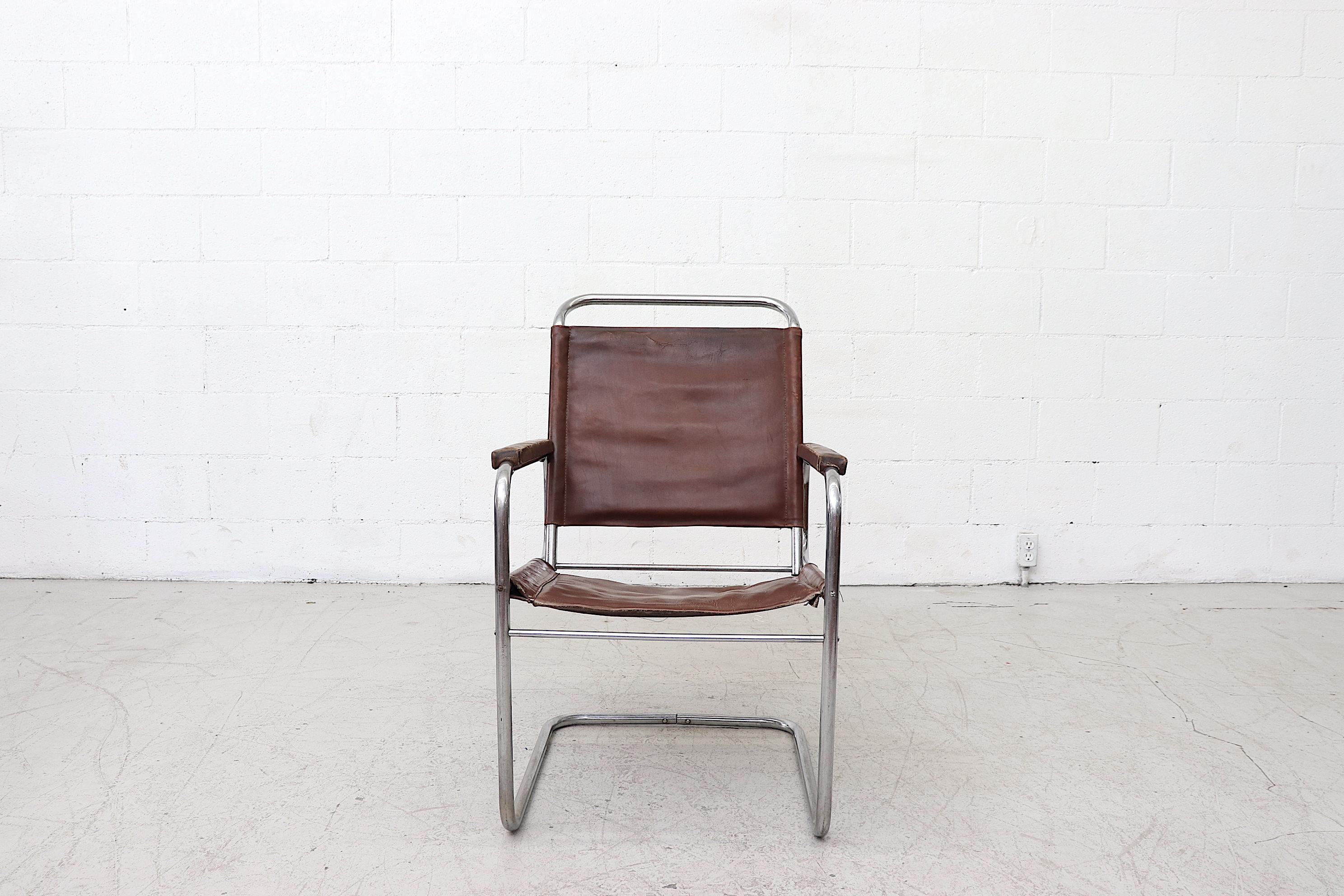 Cantilevered, quintessential Bauhaus leather armchair with tubular chrome frame. In very original condition with heavy patina on leather and some chrome loss. Wear is consistent with its age and use.