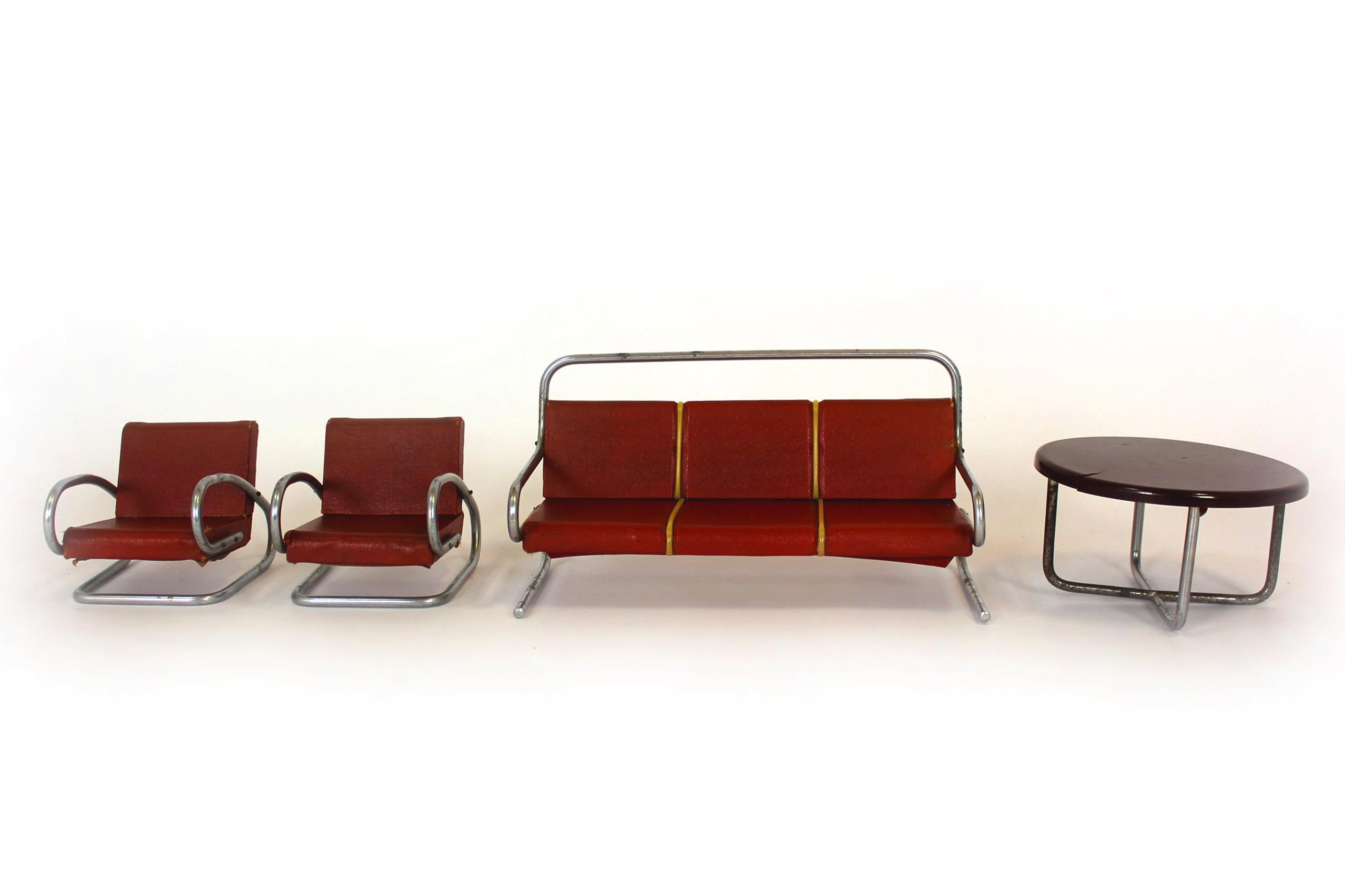 A set of miniature furniture in the Bauhaus style, designed by Jindrich Halabala. Produced in the 1930s in Czechoslovakia, miniatures of this type were used as show models. The set consists of a sofa, two armchairs and a table.
