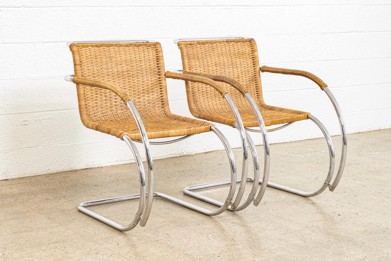 This pair of vintage Mies van der Rohe MR 20 cantilevered cane arm chairs made by Stendig are circa 1970. The MR chair was designed by modernist architect Mies van der Rohe in 1927 as part of his contribution to the Weissenhof exhibit in Stuttgart,