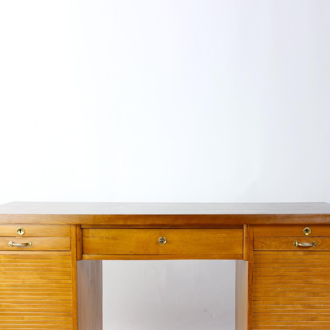 What a desk! This beautiful desk is fully restored to an amazing condition. Produced in Czechoslovakia in 1940s, the desk came to us in a rather poor condition, so we had it redone into this beautiful condition. The desk has two roller doors on each